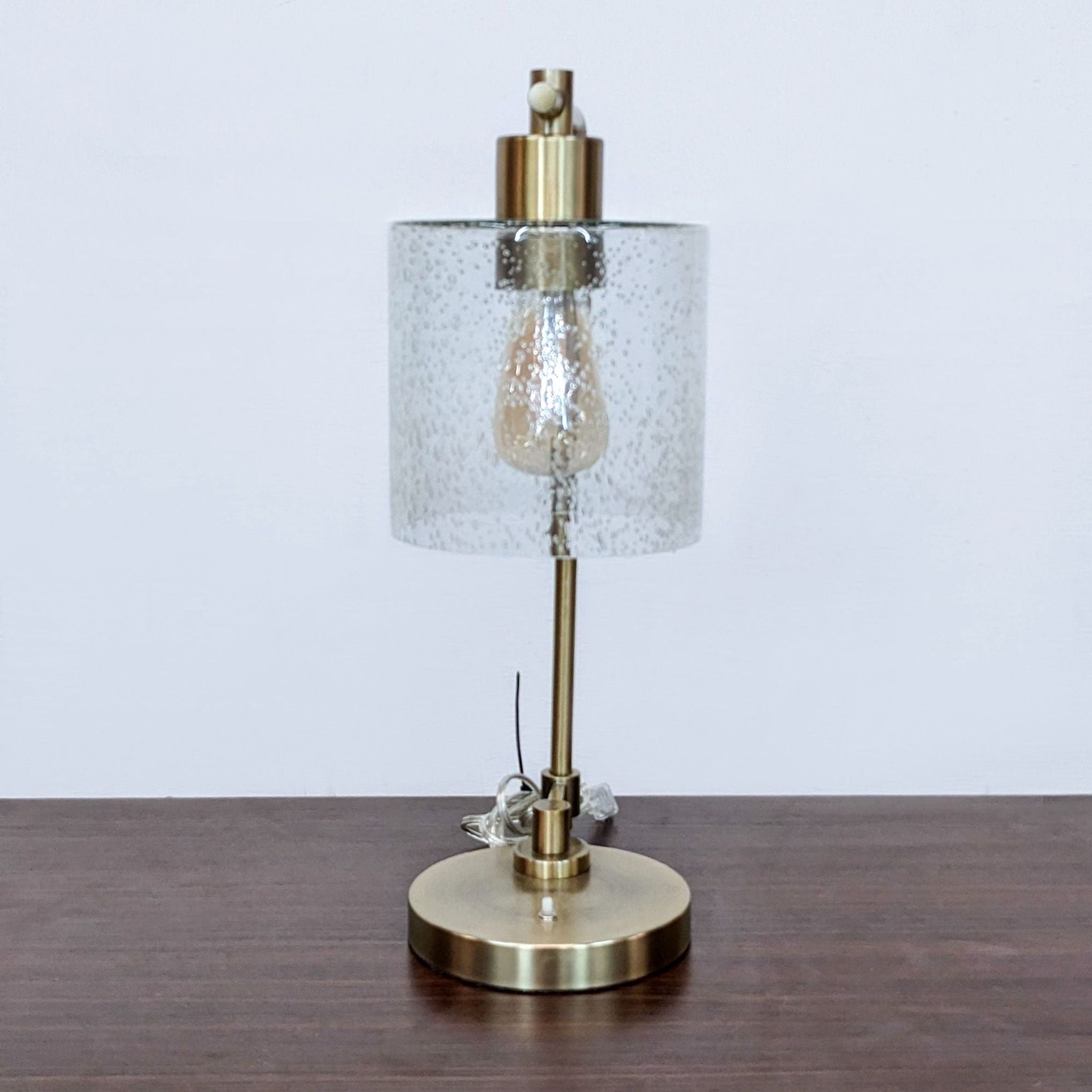 Reperch-branded modern table lamp with a speckled glass shade and gold finish on a wooden surface.