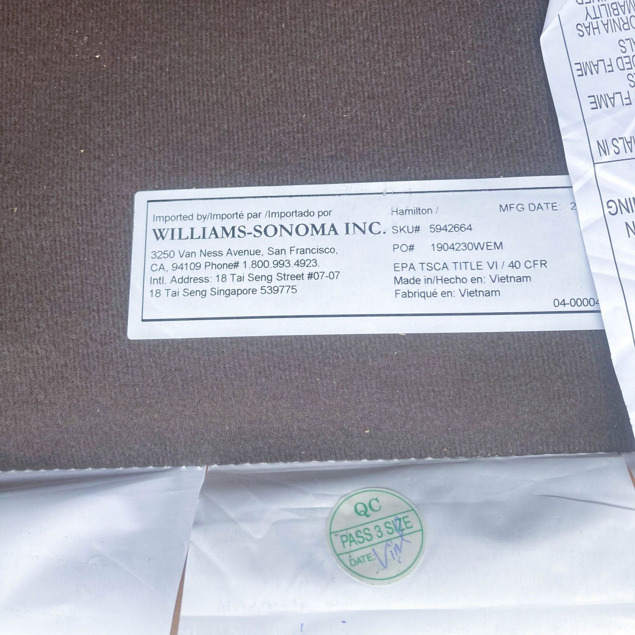 3. Information label of a West Elm Hamilton lounge chair showing import details by Williams-Sonoma Inc. and manufacturing details from Vietnam.