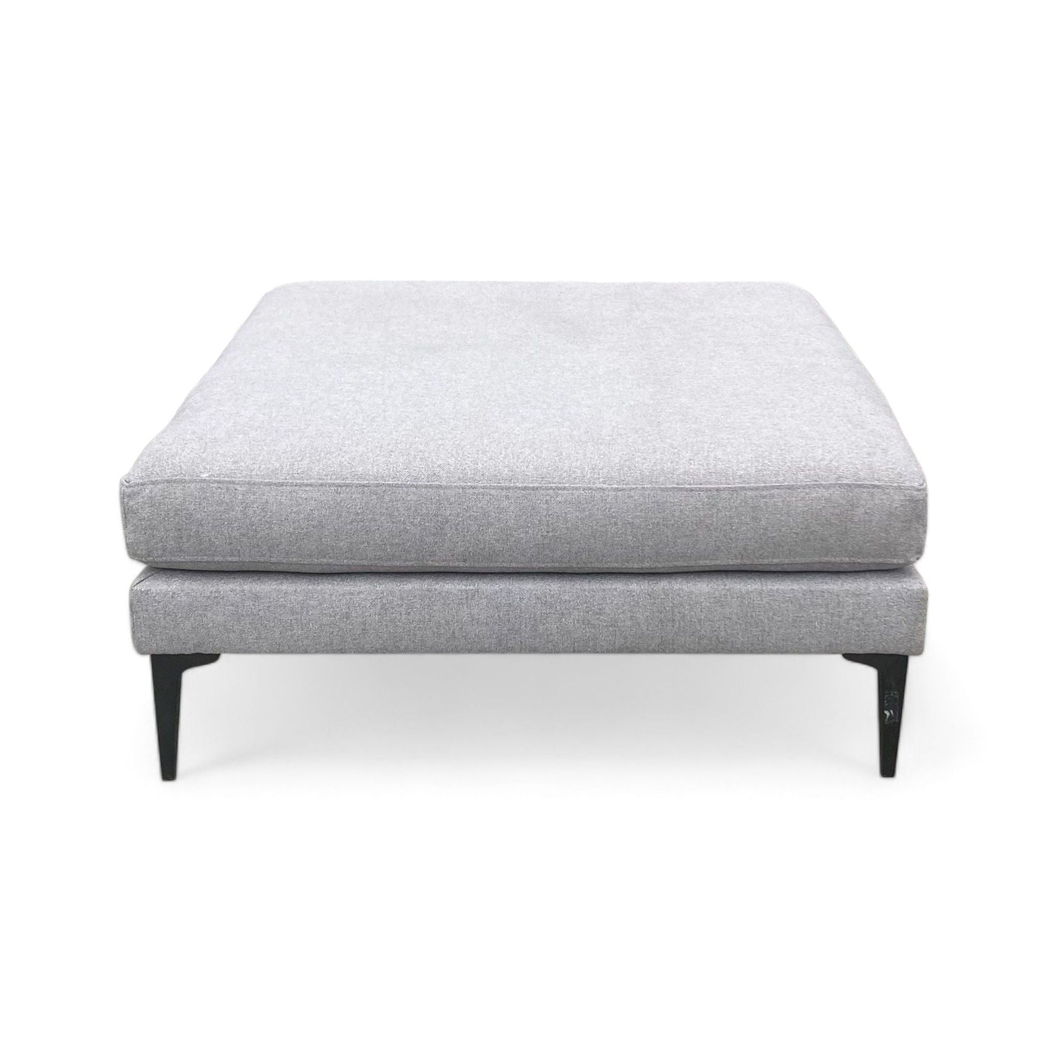 Alt text 1: Grey chenille tweed ottoman with 40" square cushion on dark pewter metal legs by West Elm.