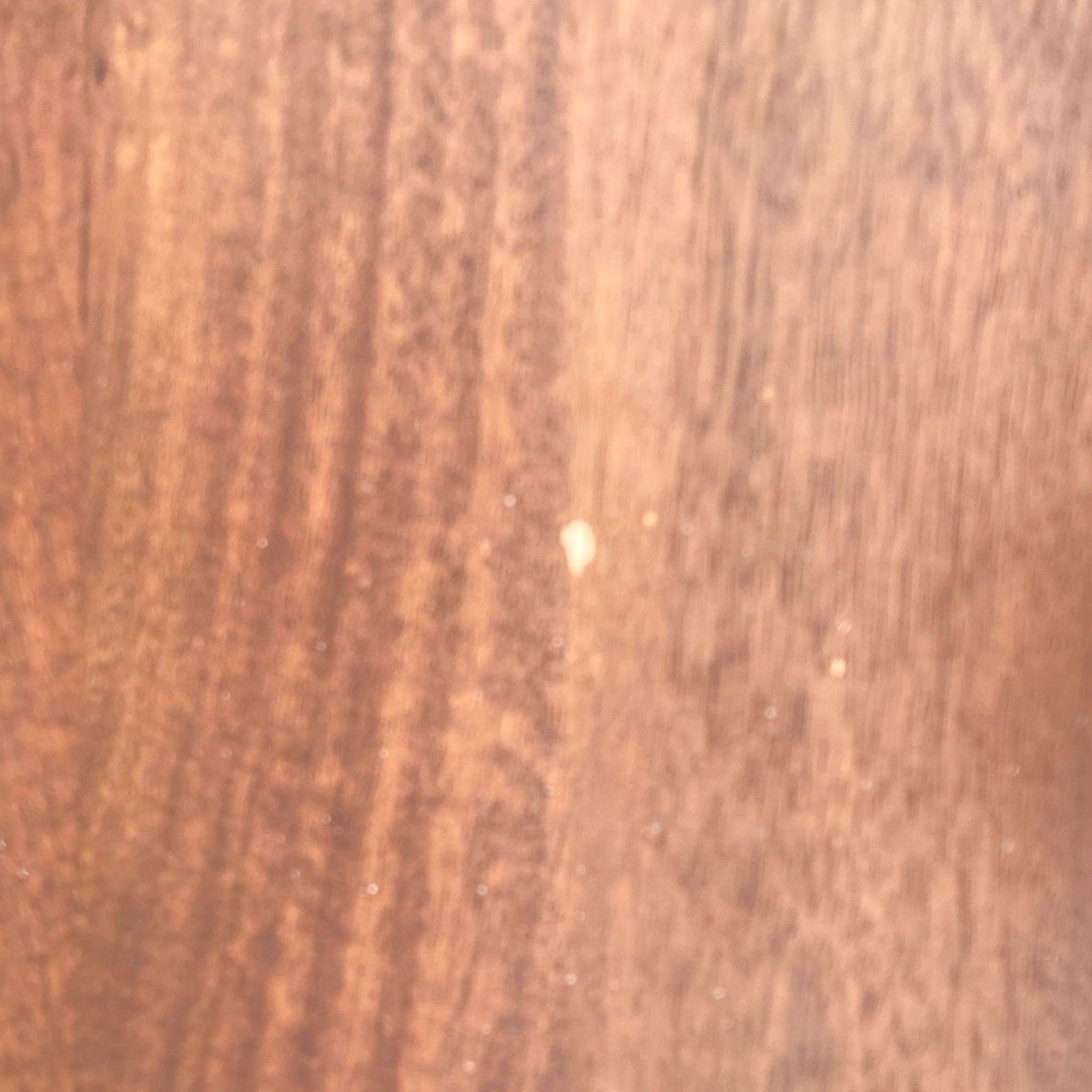 Close-up texture of a Williams Sonoma lift-top coffee table on a metal frame, showing wood detail.