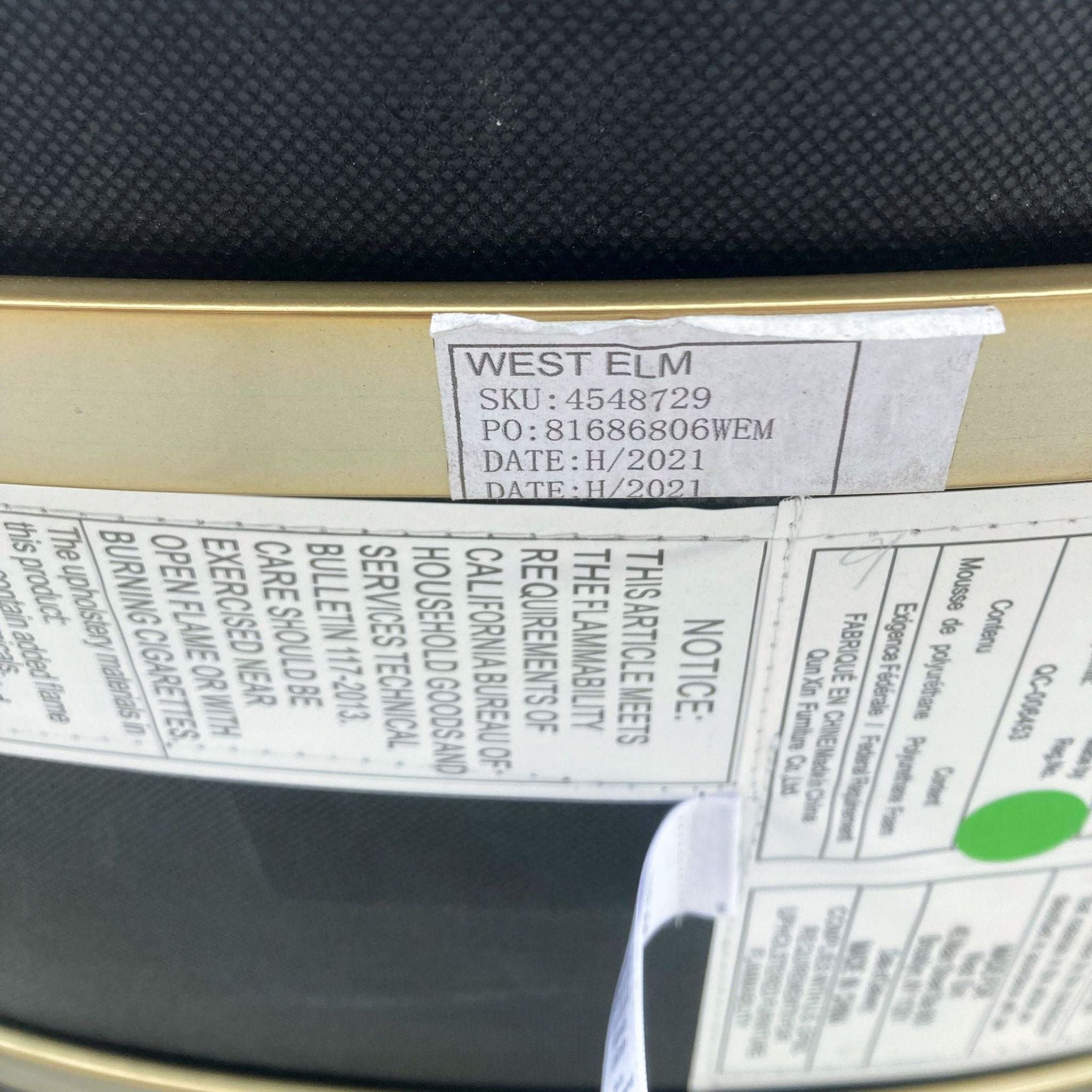 Detail of West Elm SKU and product information on a label attached to a stool.