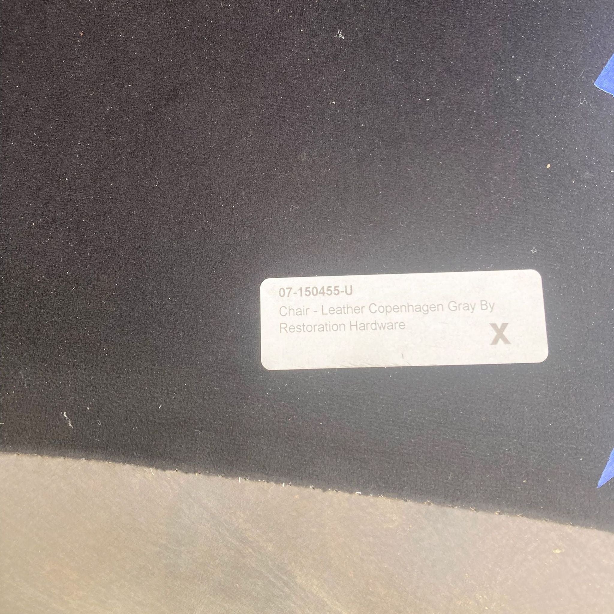 Label showing Restoration Hardware's Leather Copenhagen Gray chair specification.