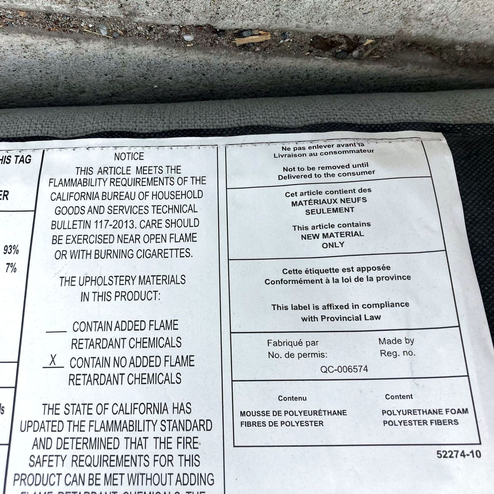 3. Warning tag in English and French on a West Elm furniture piece, showing material details and legal notices.