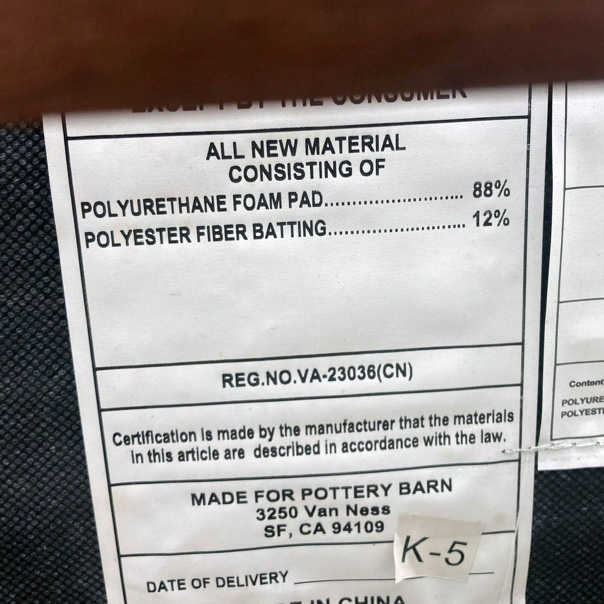3. "Detailed product tag showing material composition for a Pottery Barn padded item, made in China."