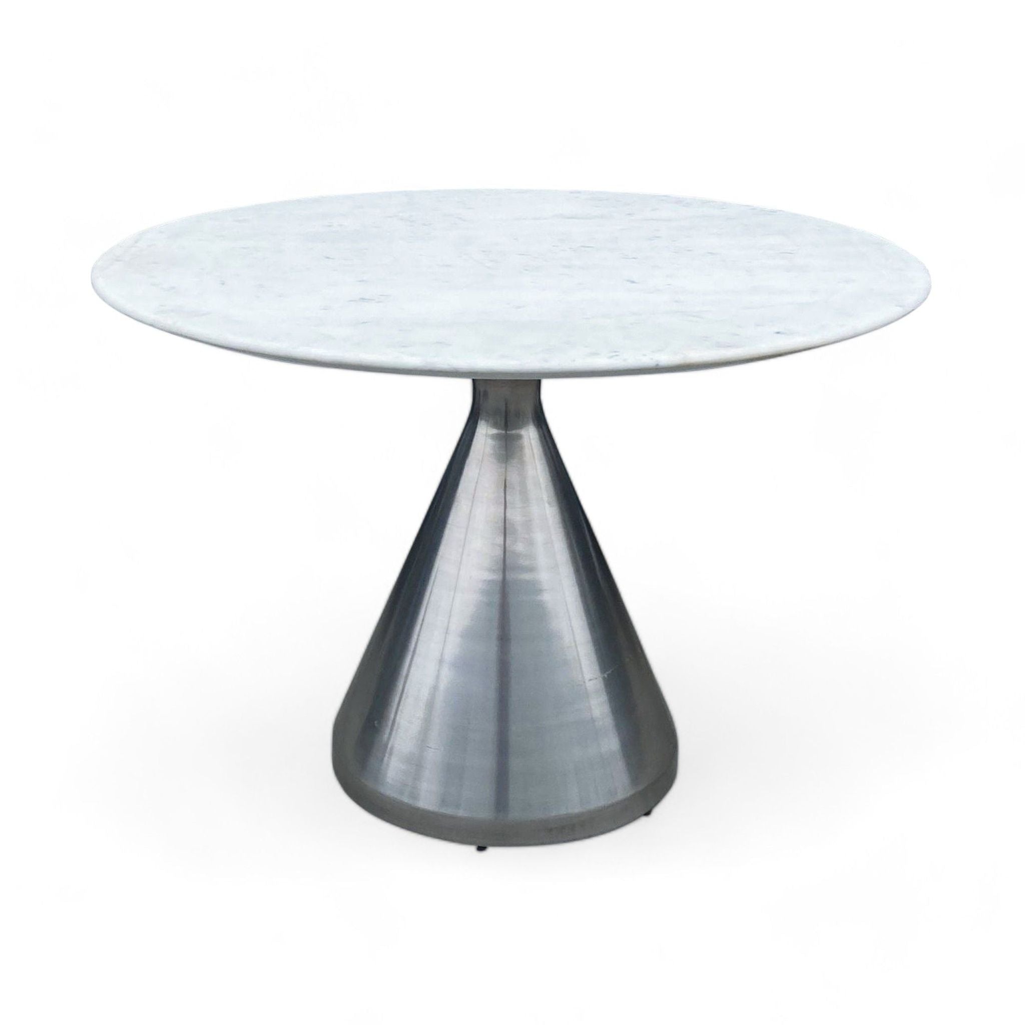 Contemporary Reperch dining table with white marble top and conical metal base.