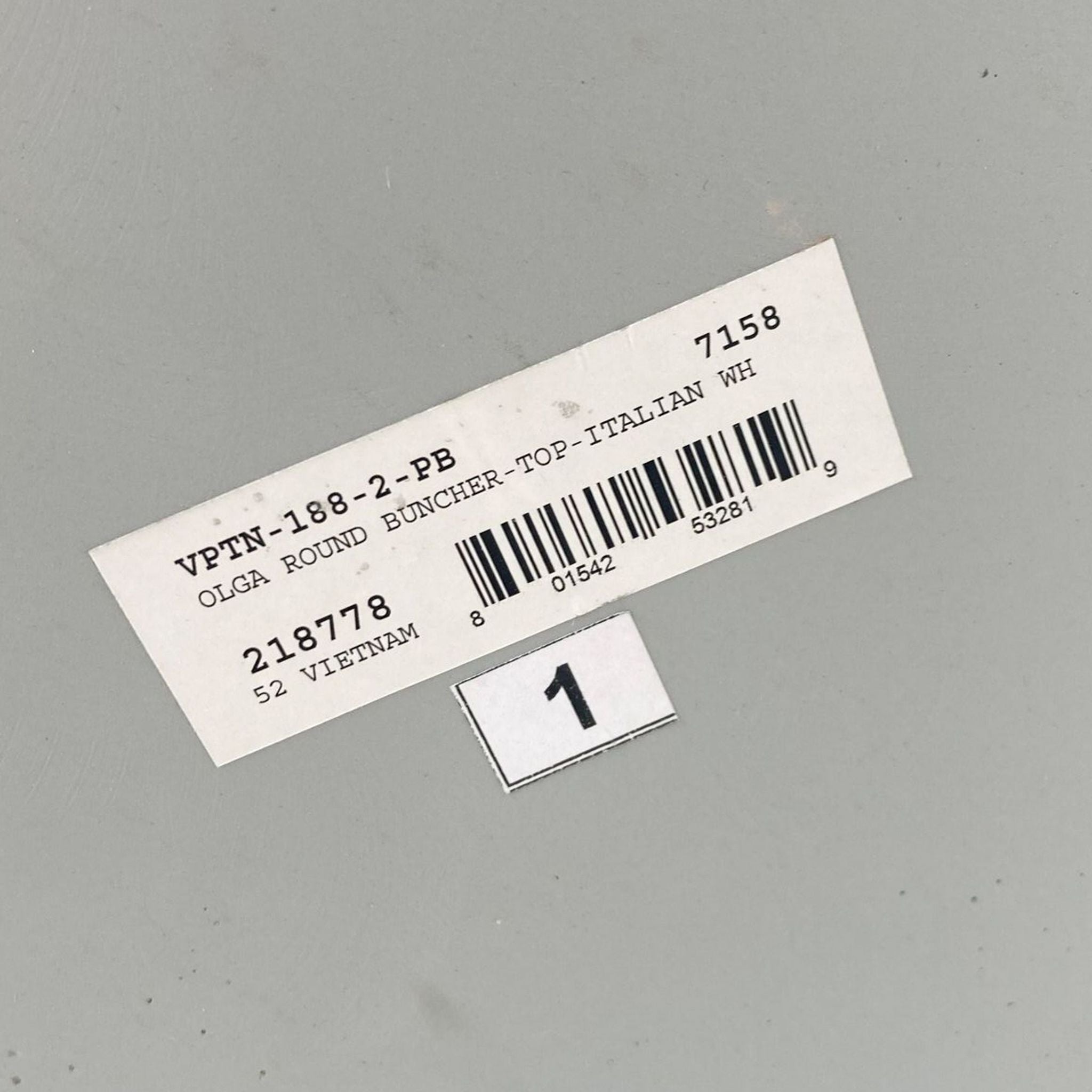 Barcode label on a grey background indicating the marble top component of a Reperch coffee table.