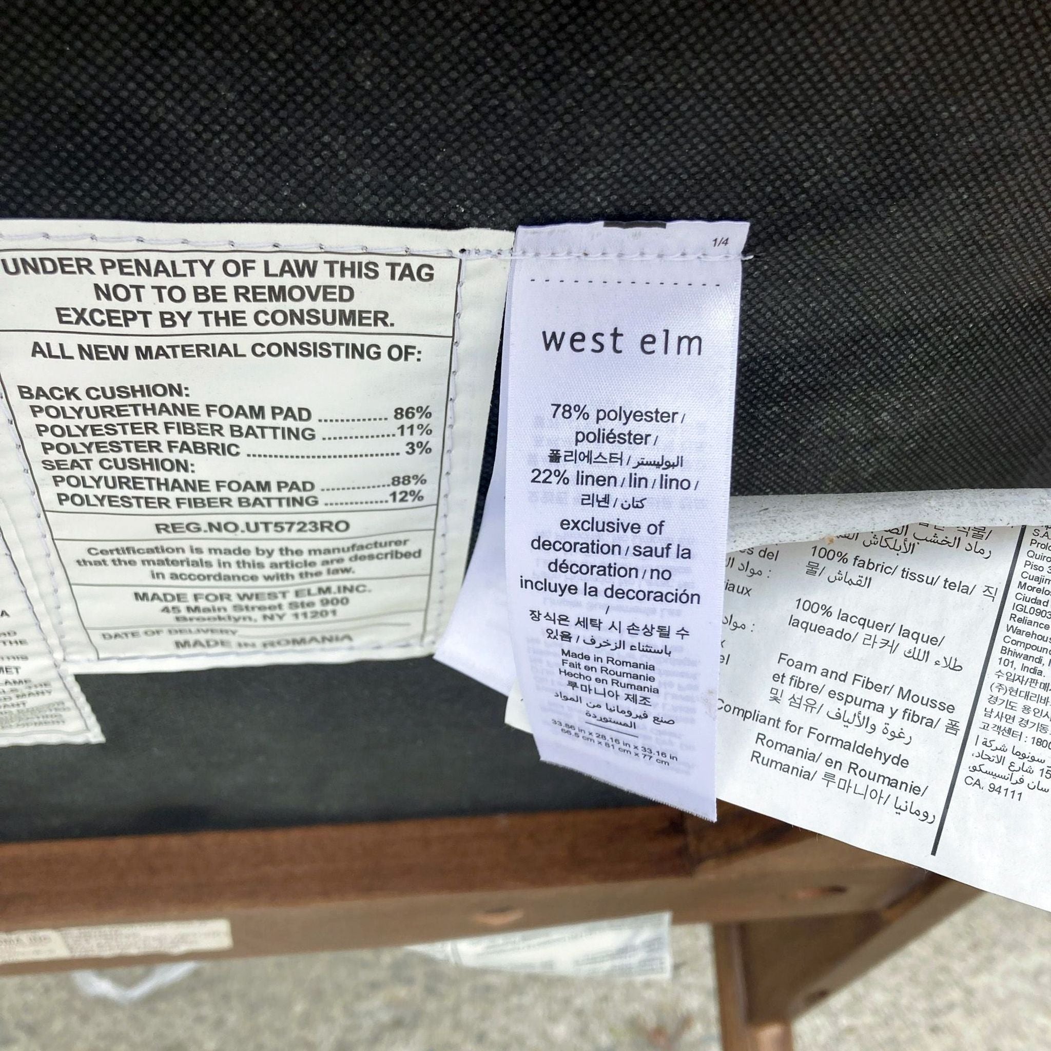 3. Care labels and material composition details on a West Elm chair, specifying polyester and linen content.