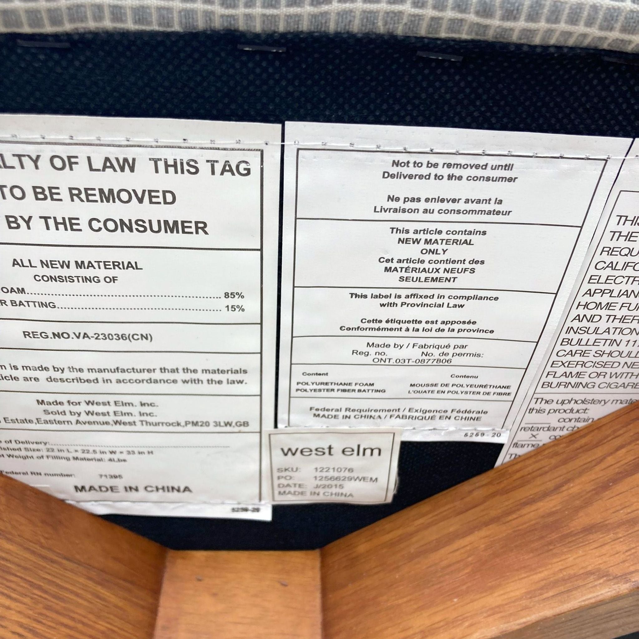 Close-up of a West Elm chair's law label with material and manufacturing details, including the brand's logo.