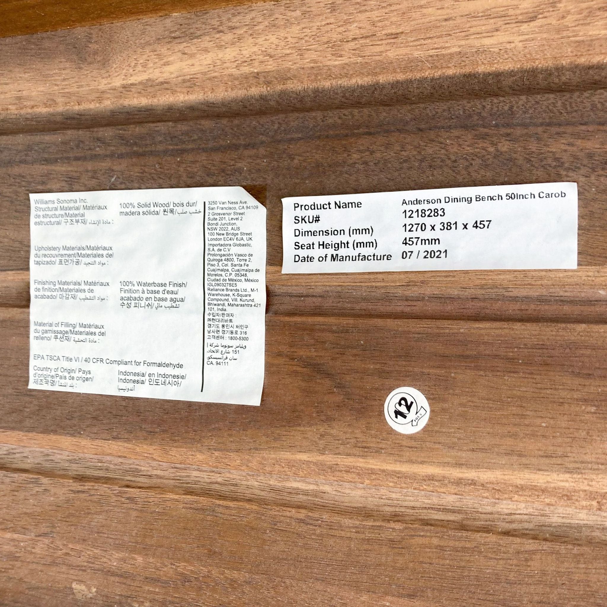 Label of West Elm's Anderson Dining Bench detailing solid wood material and dimensions in mm.