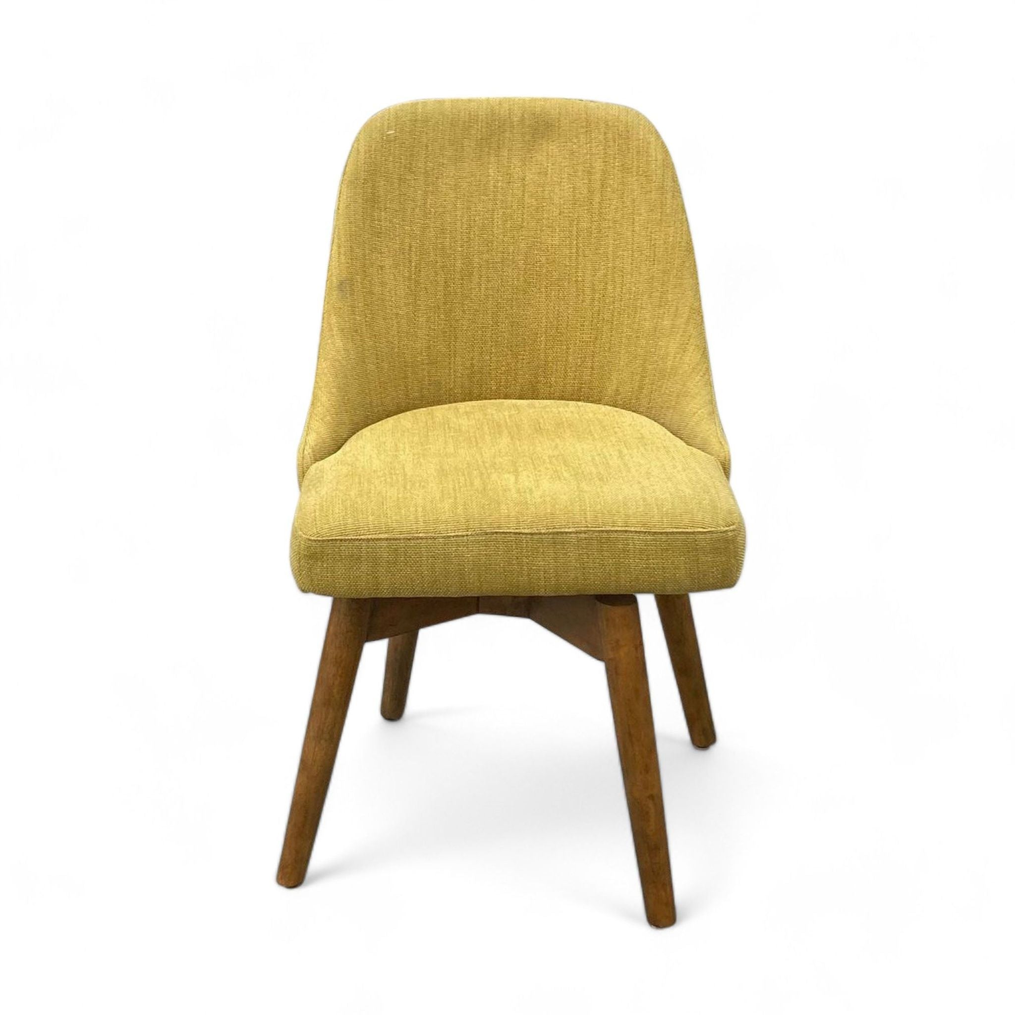 West Elm dining chair with a wide cushioned seat, sloping back, and wood swivel base against a white background.