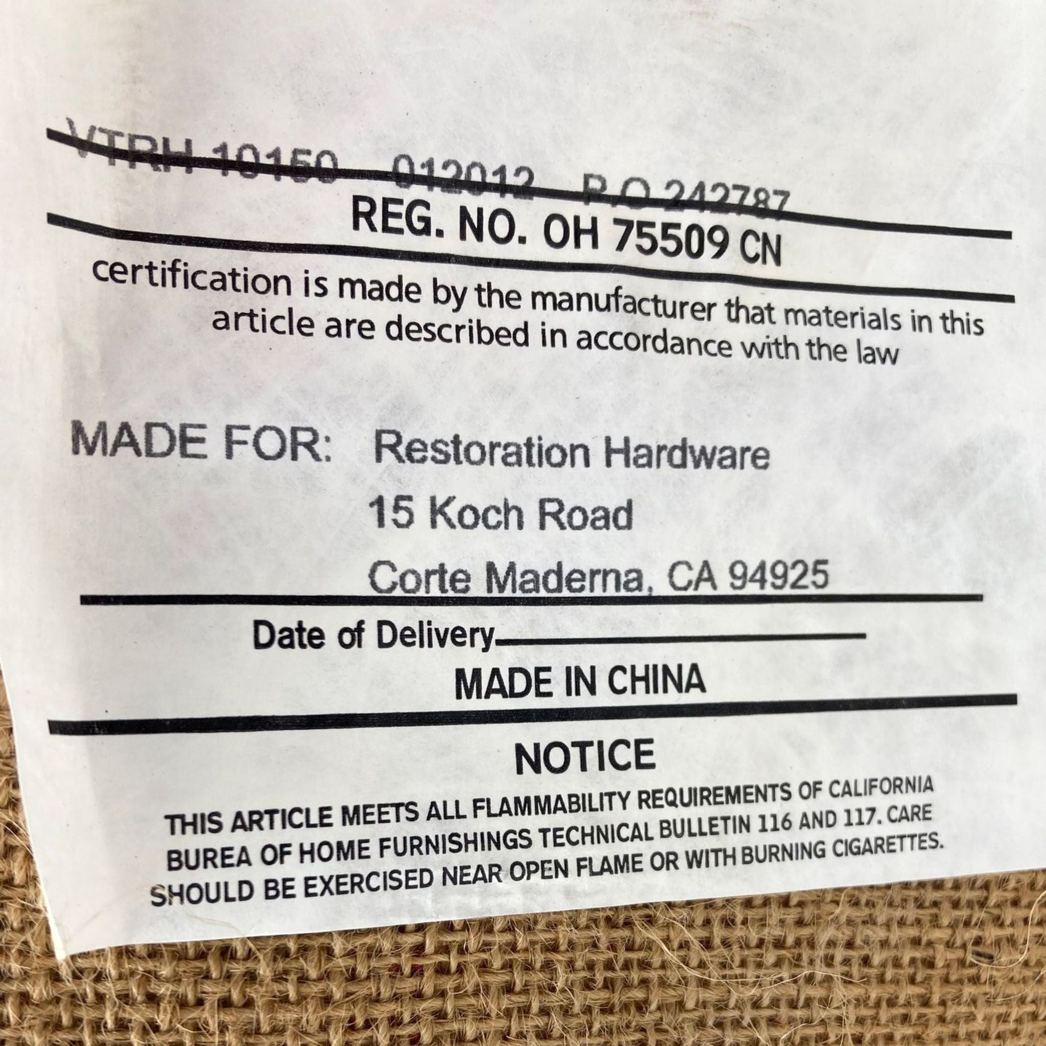 2. Close-up of the label for a Restoration Hardware lounge item showing the product meets safety standards.