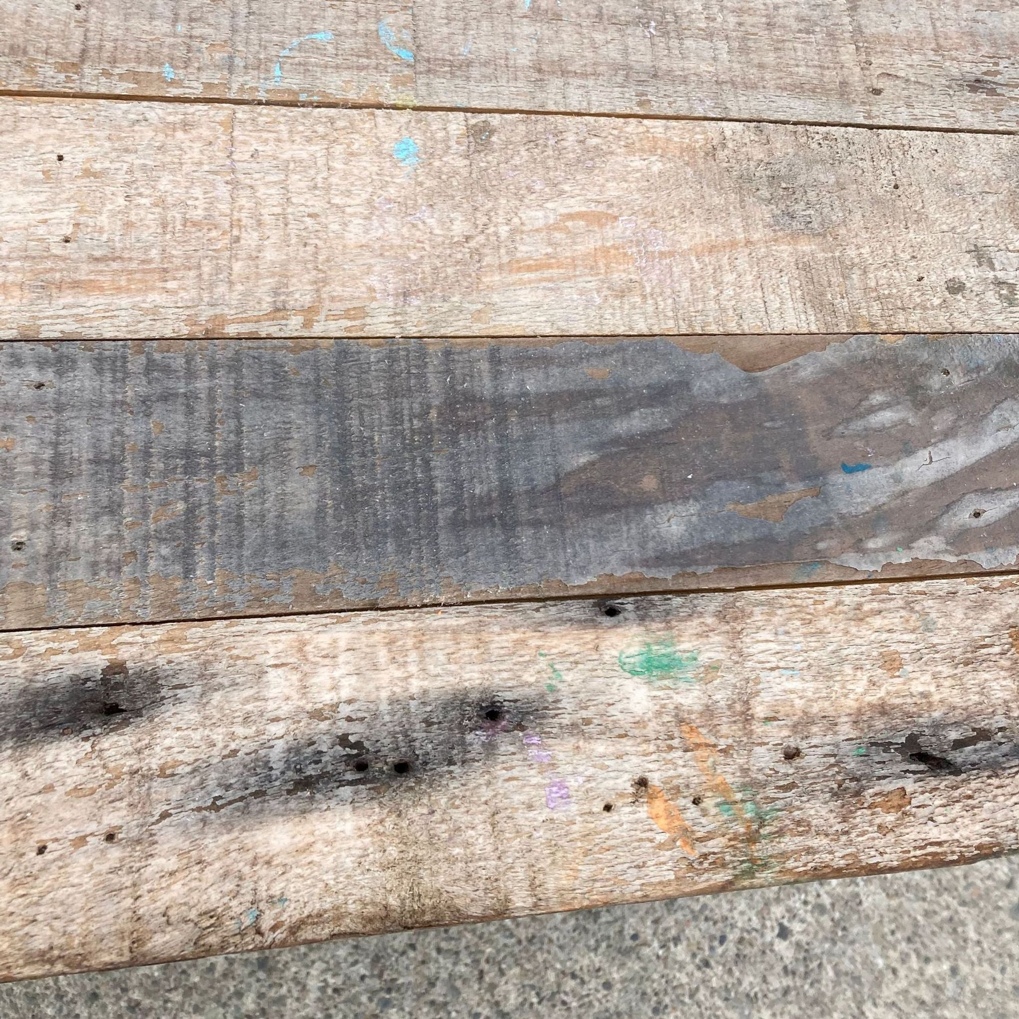 2. "Close-up texture of Reperch rustic recycled wood bench showing wood grain and color details."