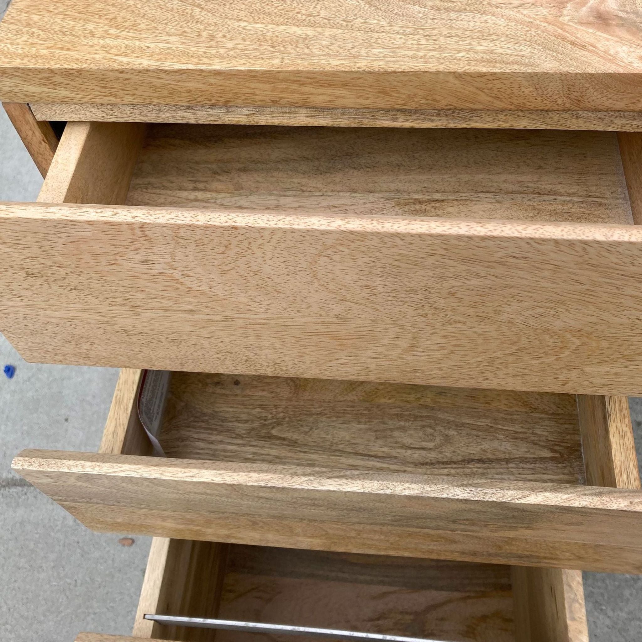 Alt text 2: Close-up of open drawers in a solid mango wood desk revealing the wood grain and quality of construction.