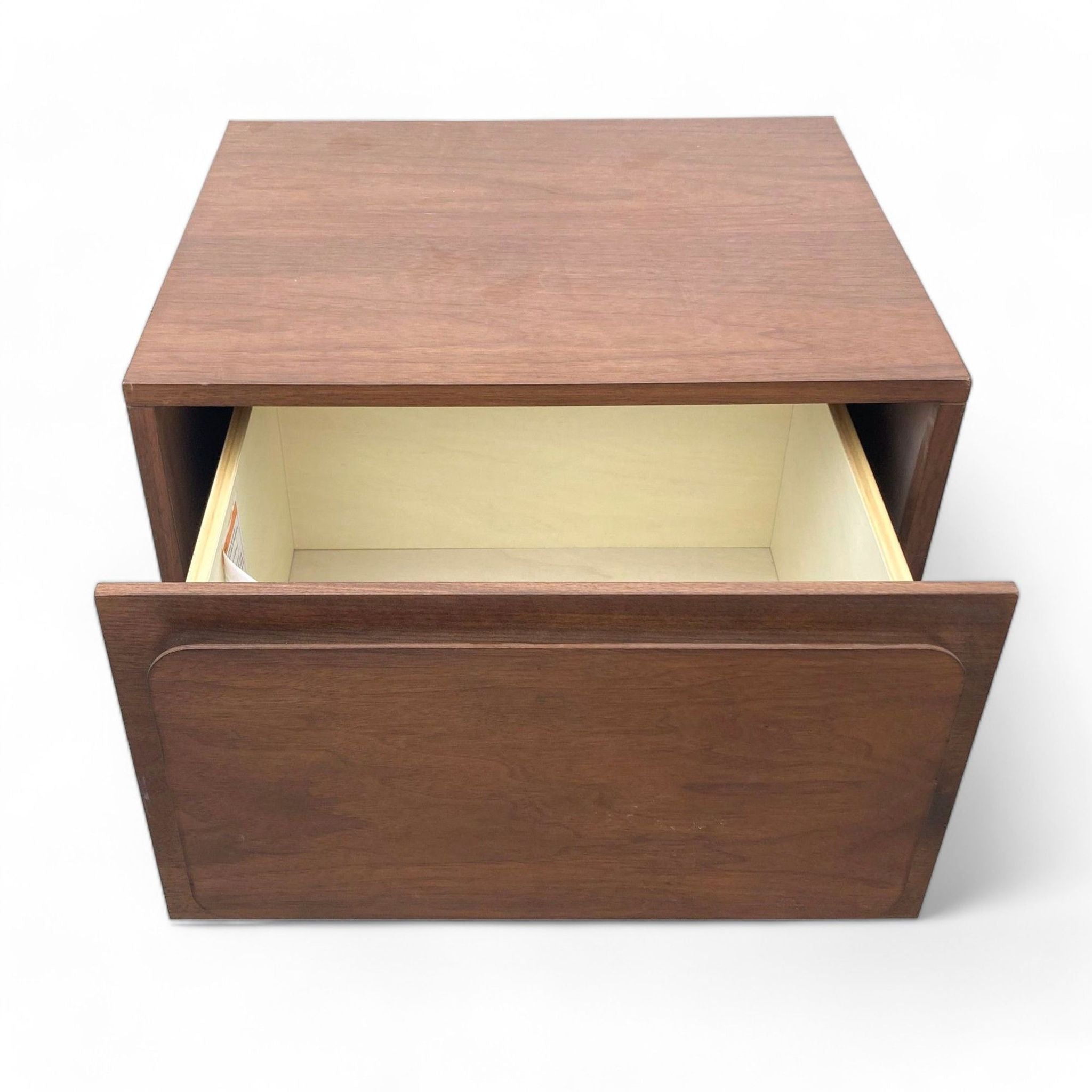 2. Open drawer of a dark walnut West Elm end table, revealing inside storage with a light interior.