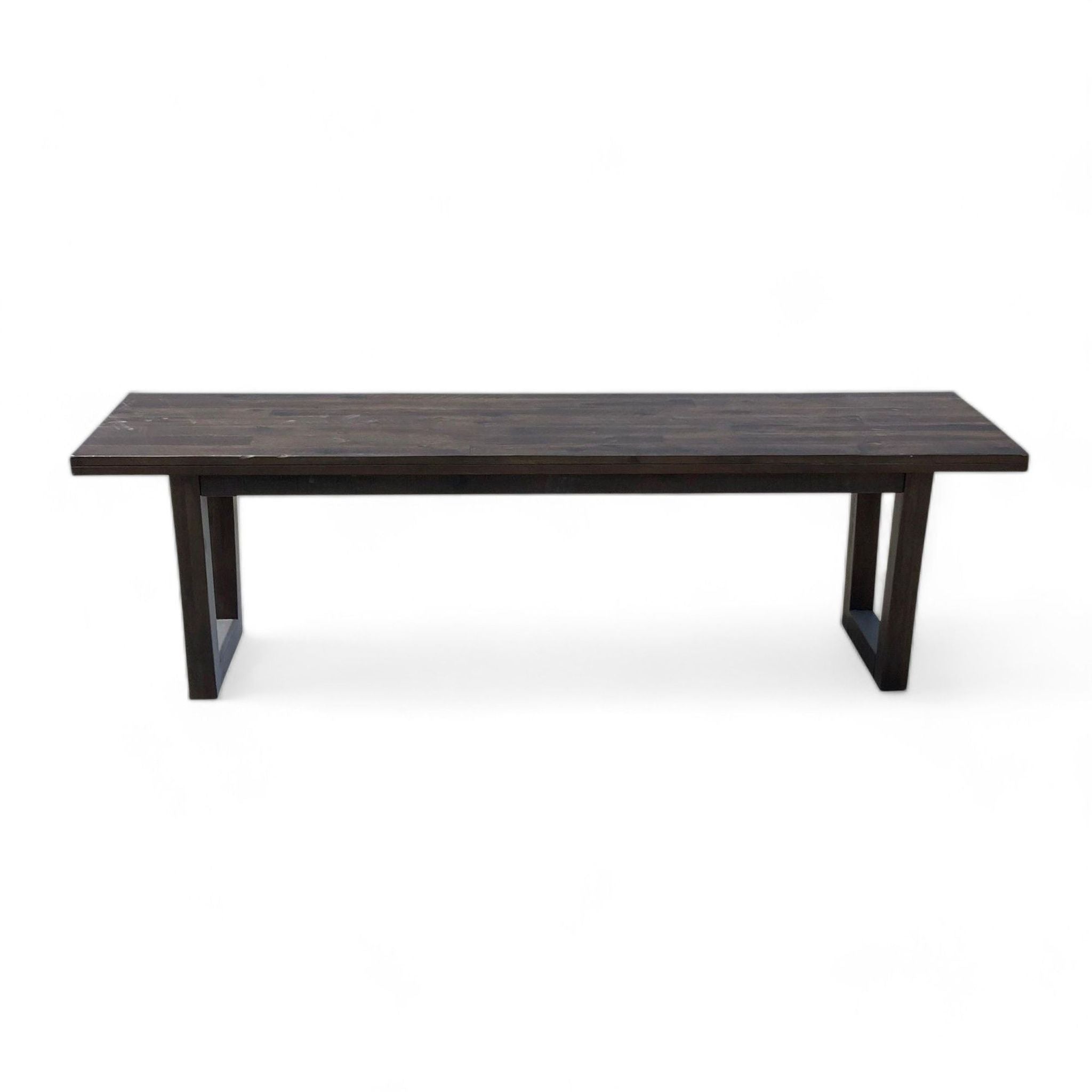 Alt text 1: A dark finish, rustic solid wood dining bench with sleek metal legs, from West Elm's furniture collection.