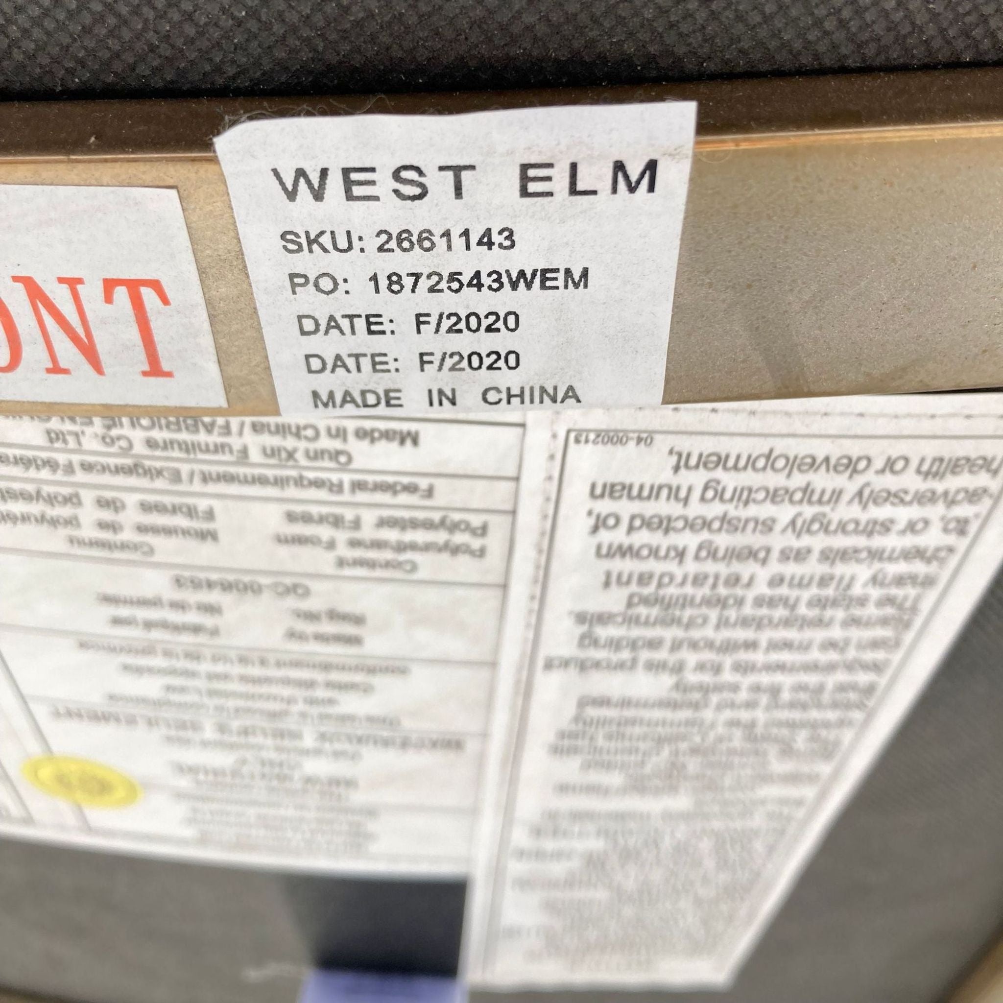 Label showing the West Elm brand, SKU, and manufacture details on a chair.
