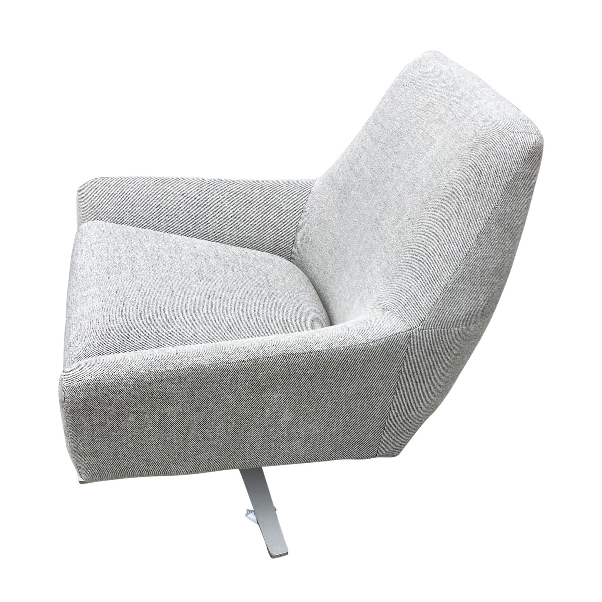 Modern fabric armchair by West Elm with minimalist design, three-quarter view.