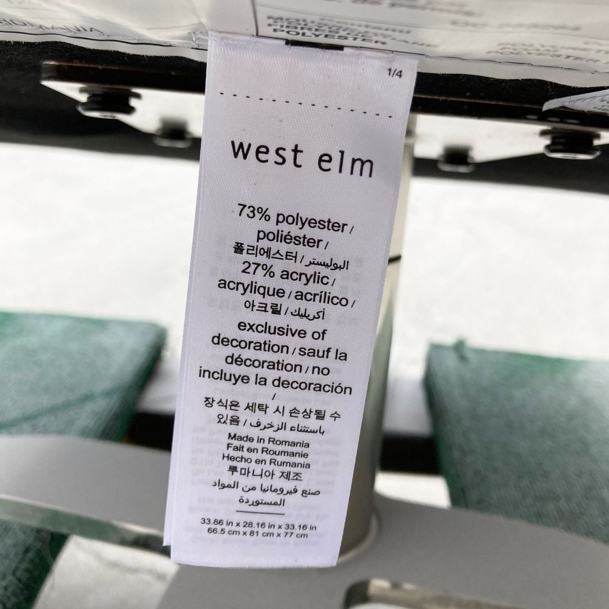 Close-up of a West Elm chair label showing material composition and manufacturing details.