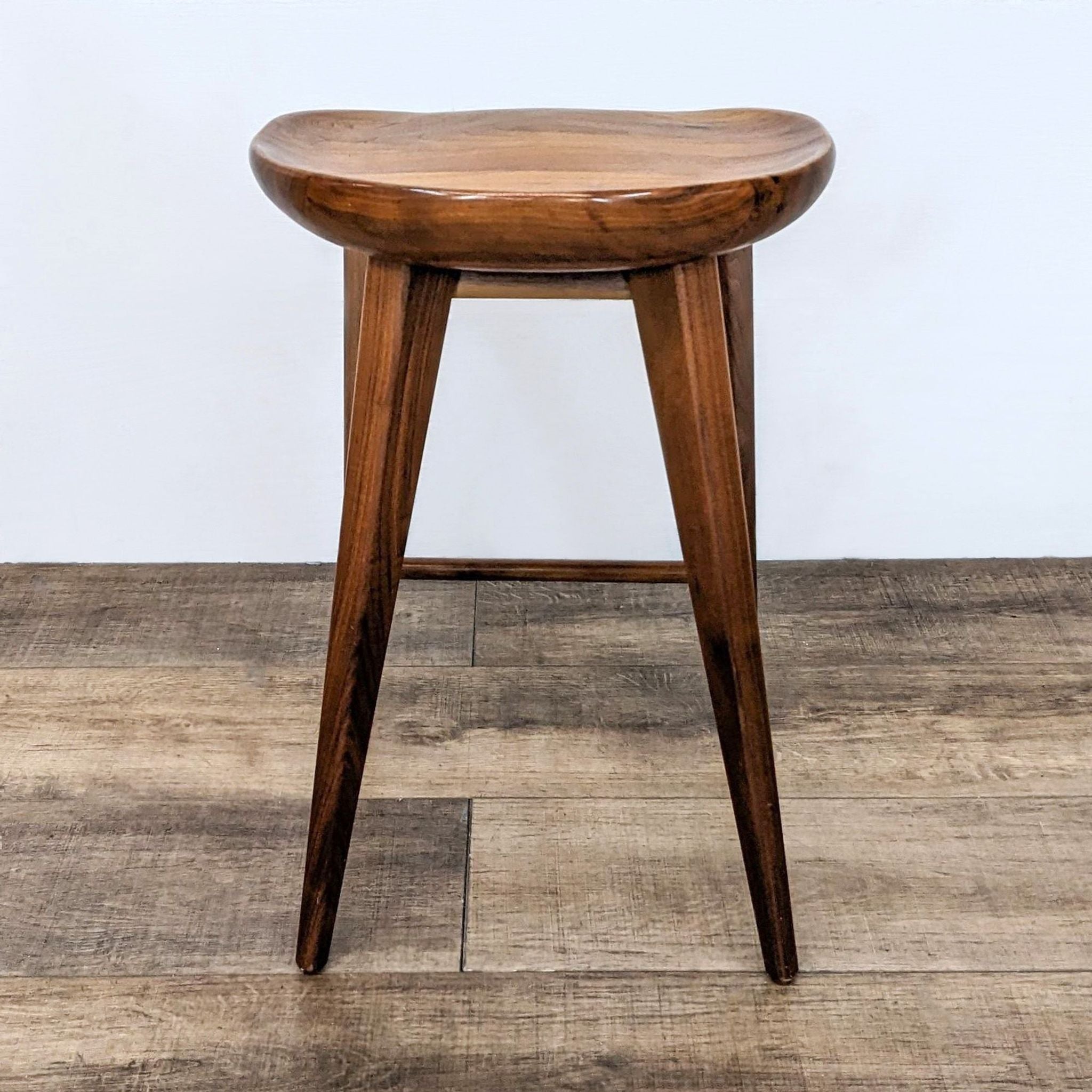 3. Angled view of a Rejuvenation solid wood stool, highlighting its sturdy design and polished surface.
