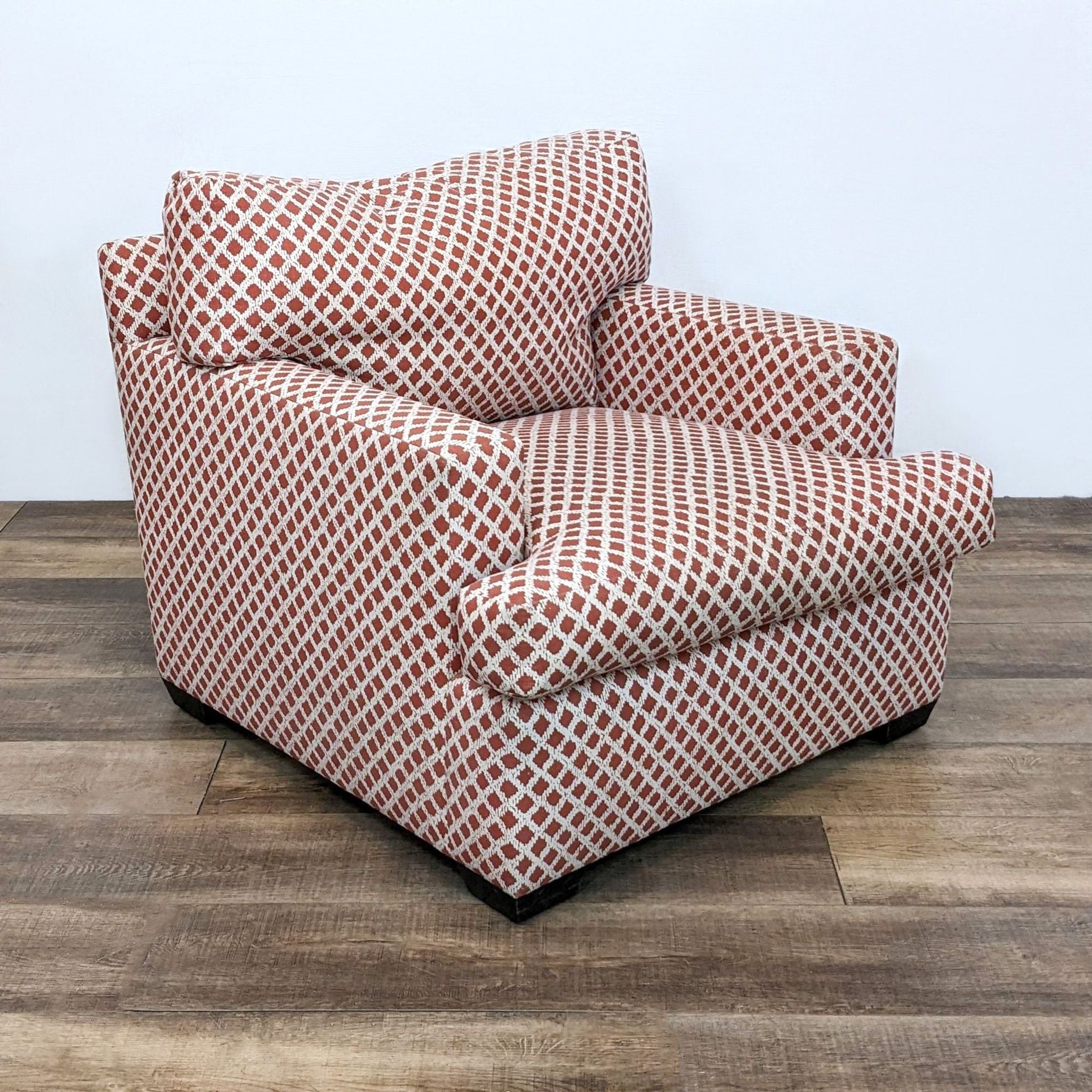 3. Red lattice upholstered A. Rudin chair at an angle, highlighting its plush cushions and contemporary style.
