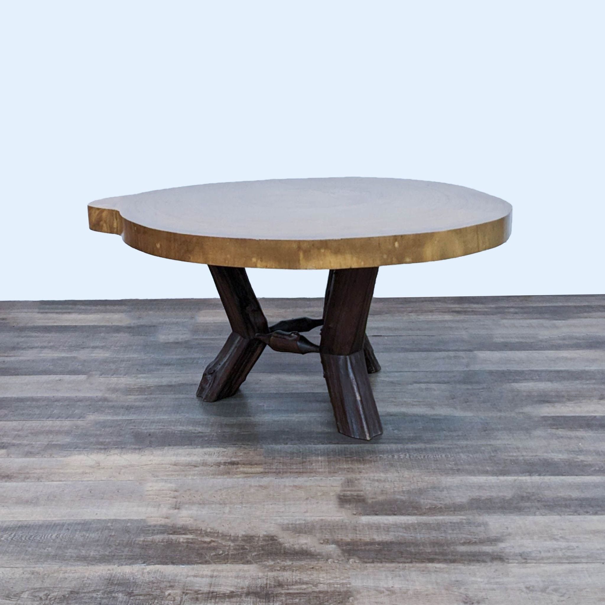 2. "Round Reperch dining table made from a Saman tree, showcasing a natural wood top and a unique tree limb base, crafted in Venezuela."
