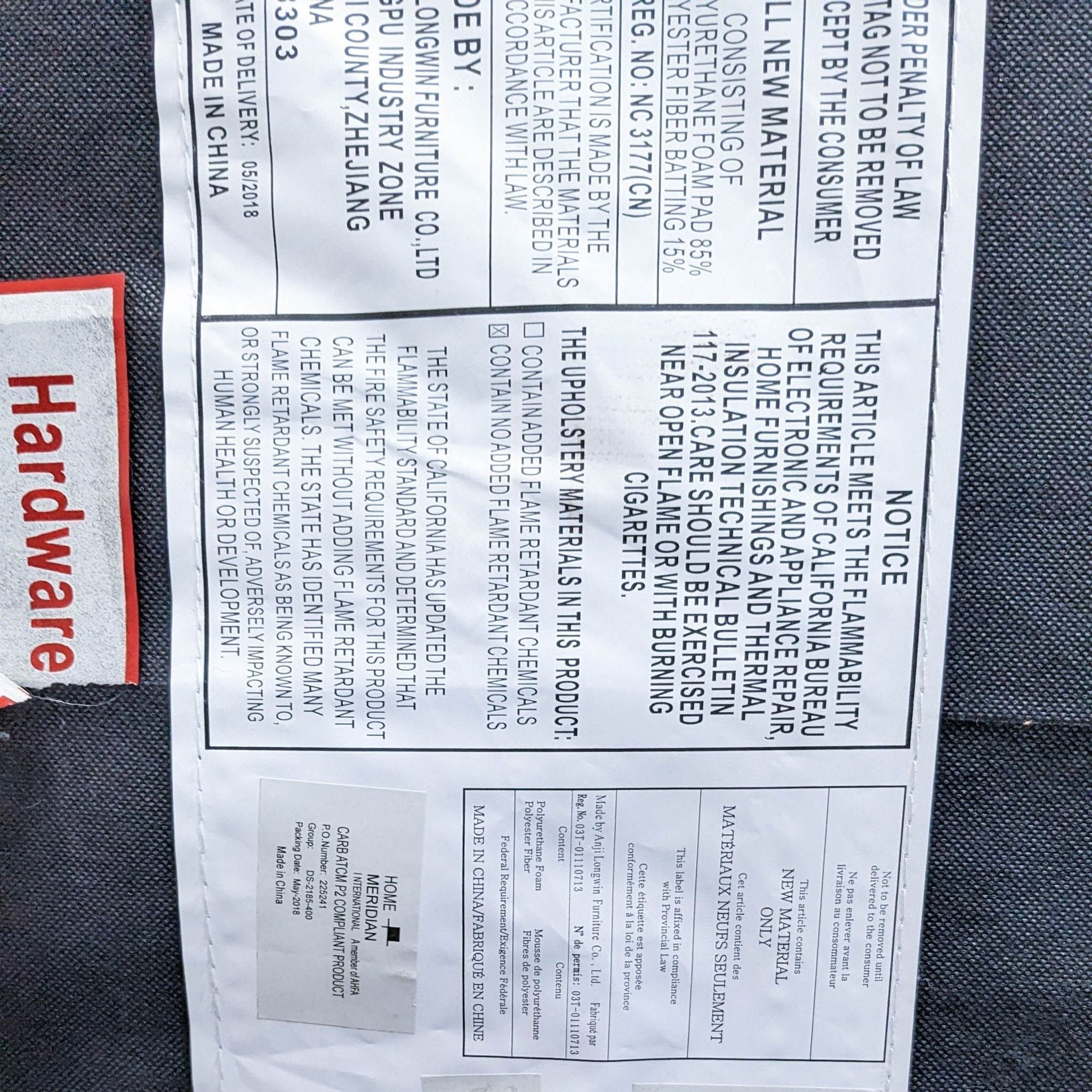 Alt text 3: Close-up of a care label on a Home Meridian dark grey loveseat detailing upholstery and safety information.