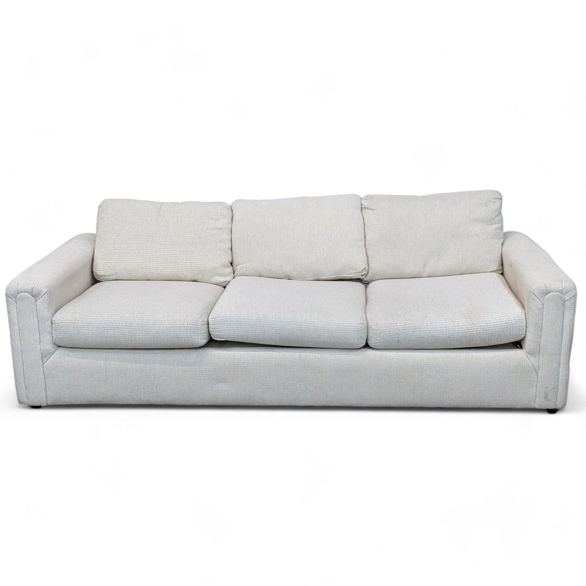 1. Neutral-colored Reperch 3-seat sofa with plush back cushions and a smooth, clean-lined fabric texture.