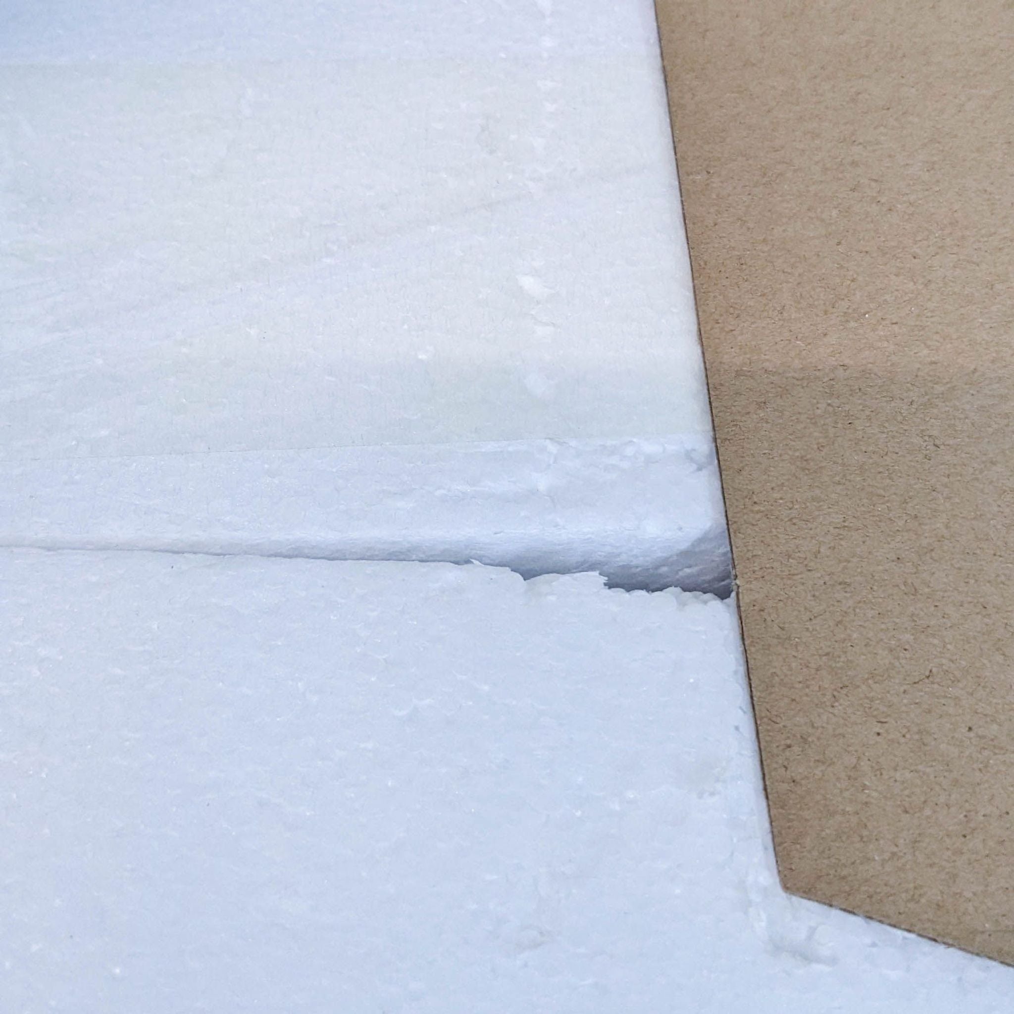 Close-up of cardboard packaging edge, showing texture and materials of the product box.