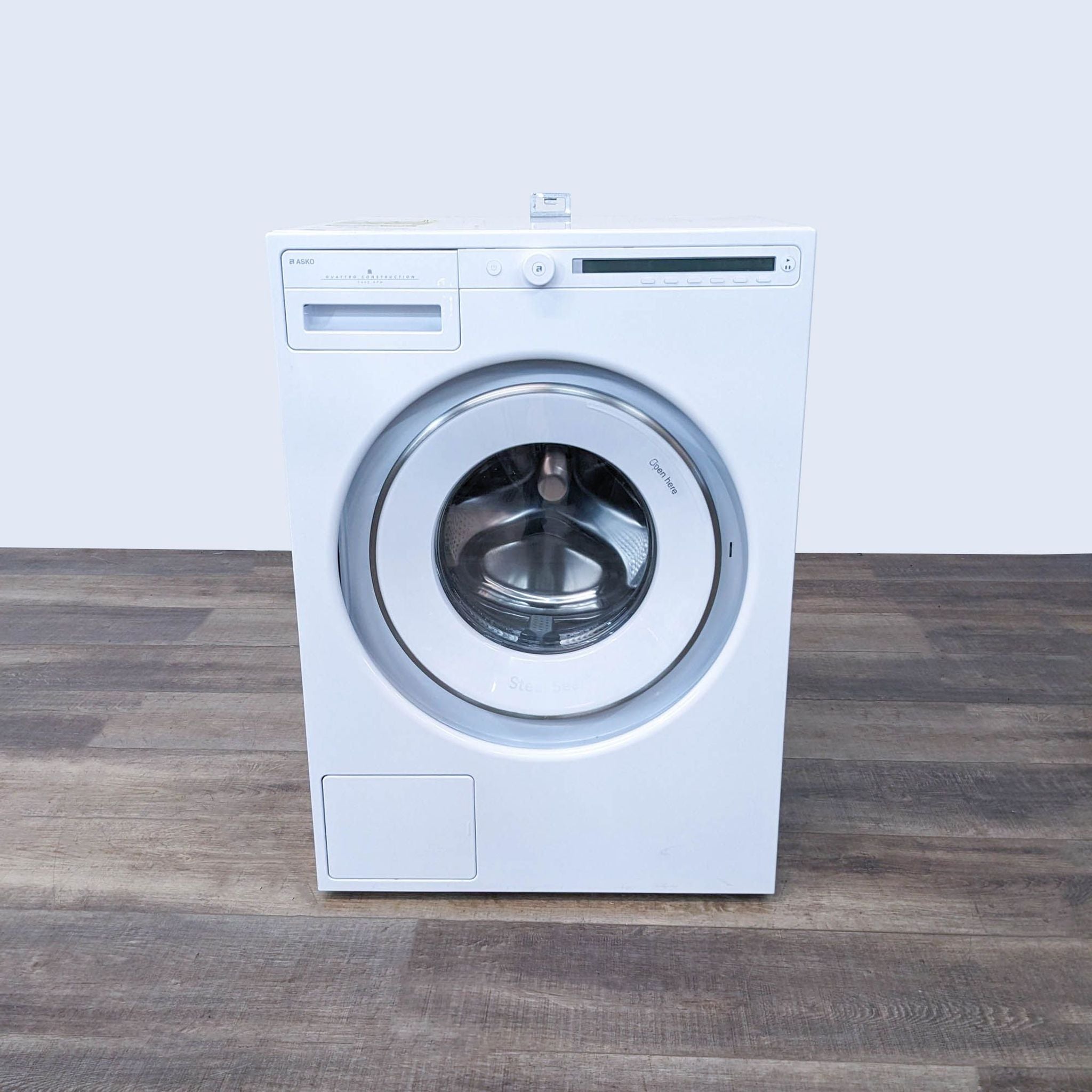 a white washing machine on a wooden table.