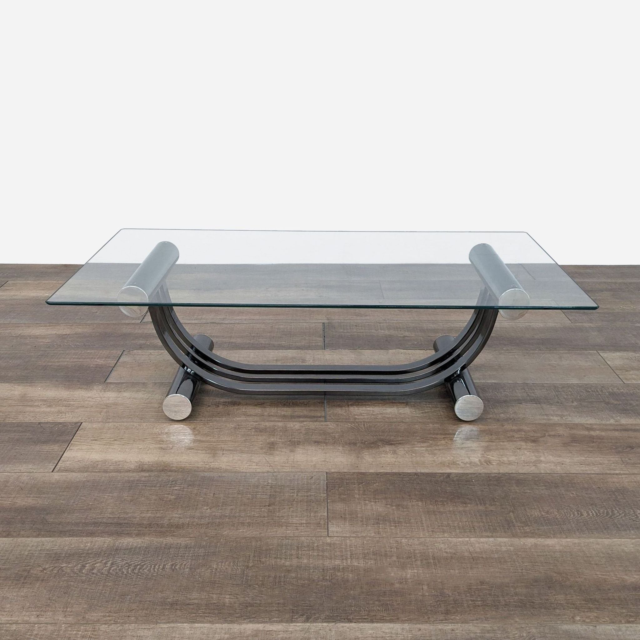 a black and chrome coffee table with a glass top.