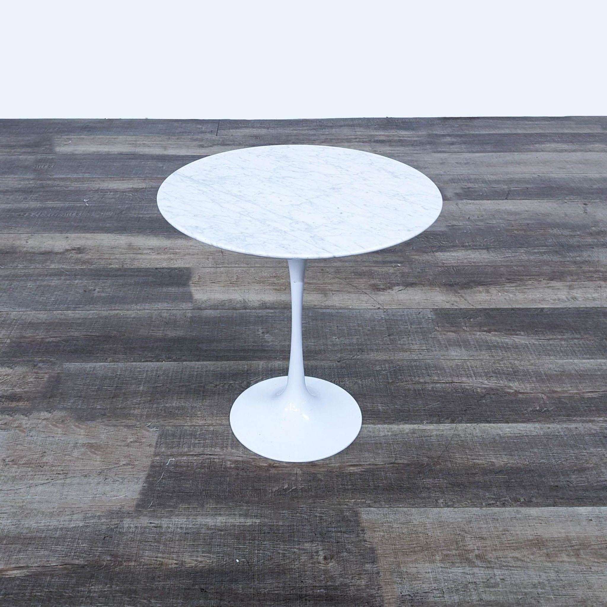 a white marble table with a white marble base