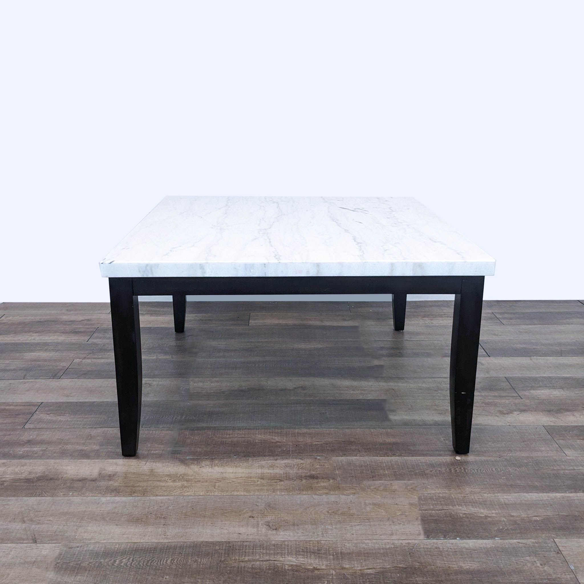 a marble coffee table with a black and white marble top.