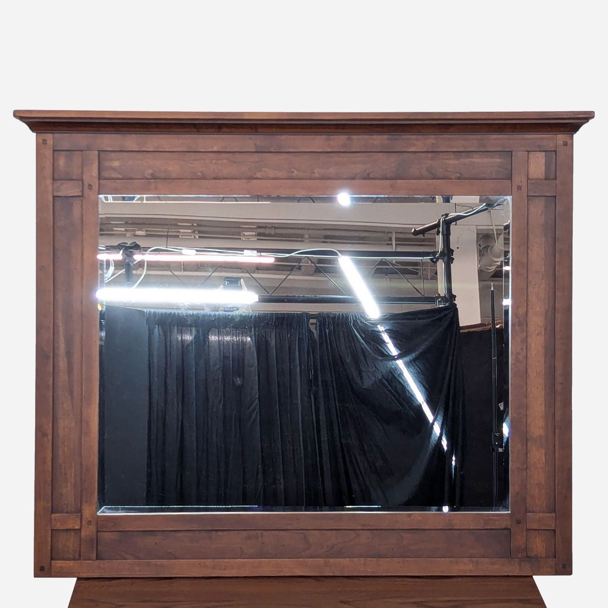 a large mirror with a dark wood frame.