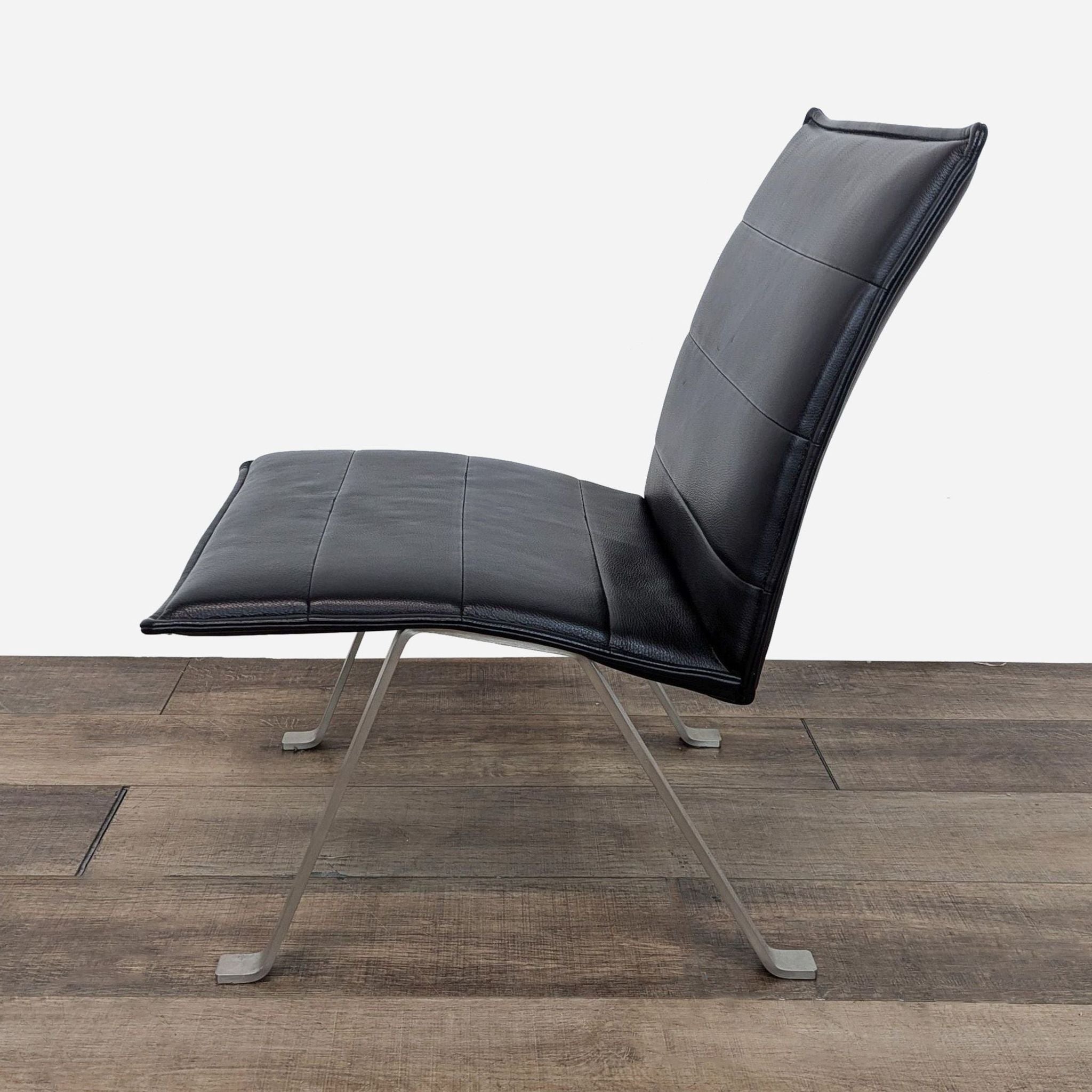 the [ unused0 ] chair in black leather with chrome legs