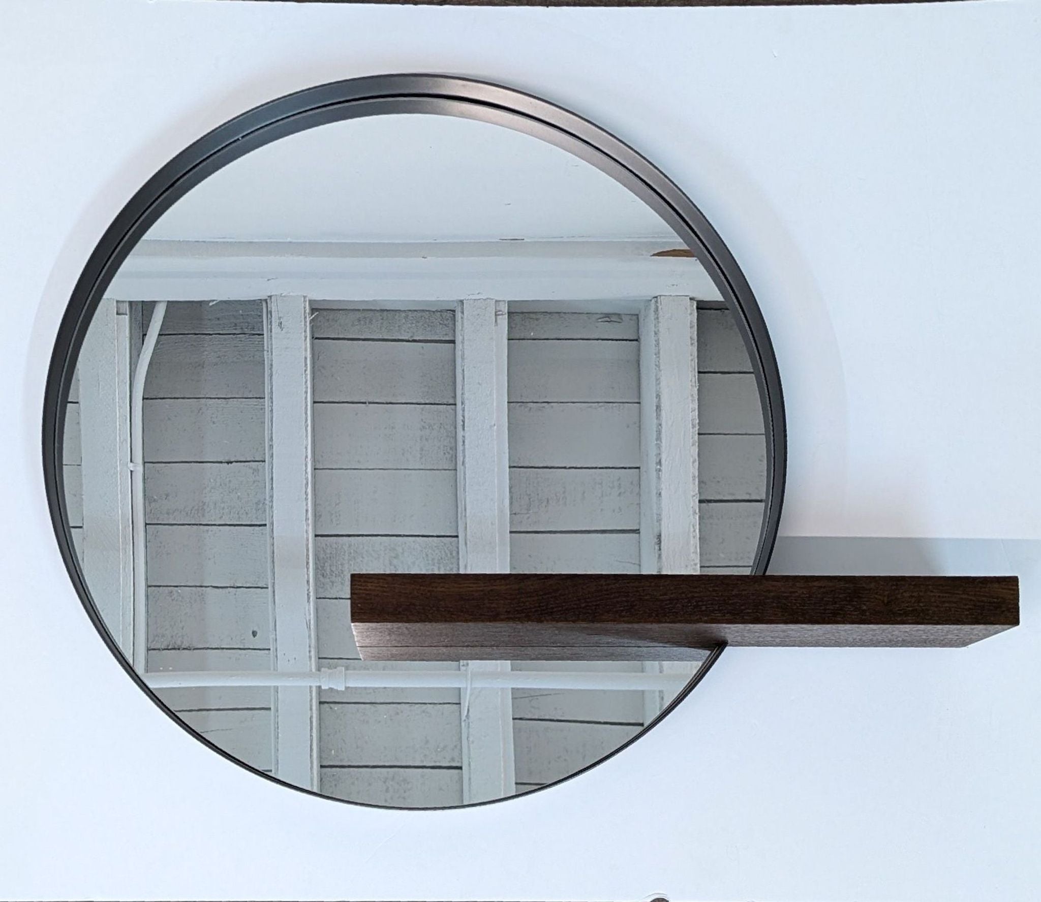 a large circular mirror with a metal frame.