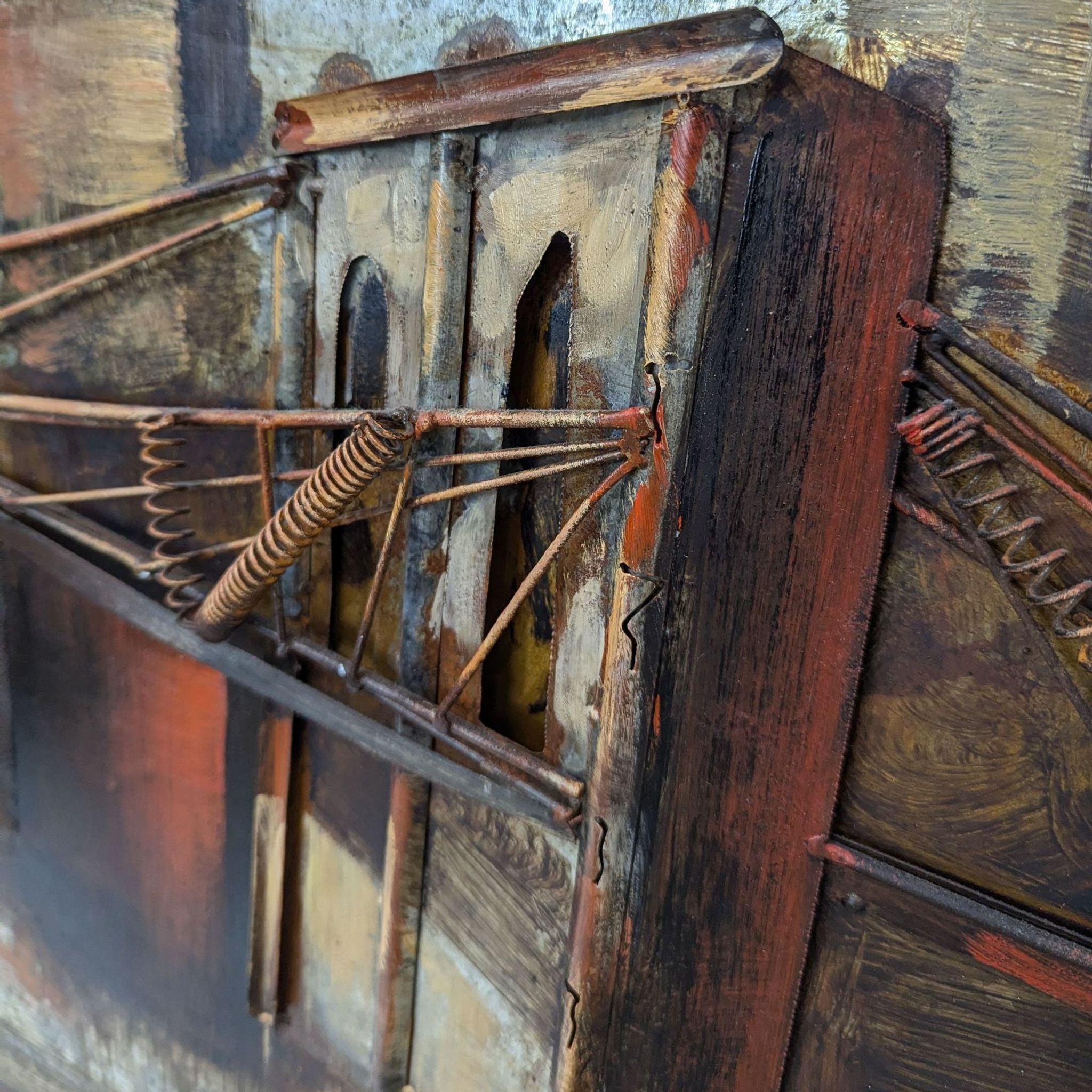 a close up of a piece of wood with metal wire and a metal frame.