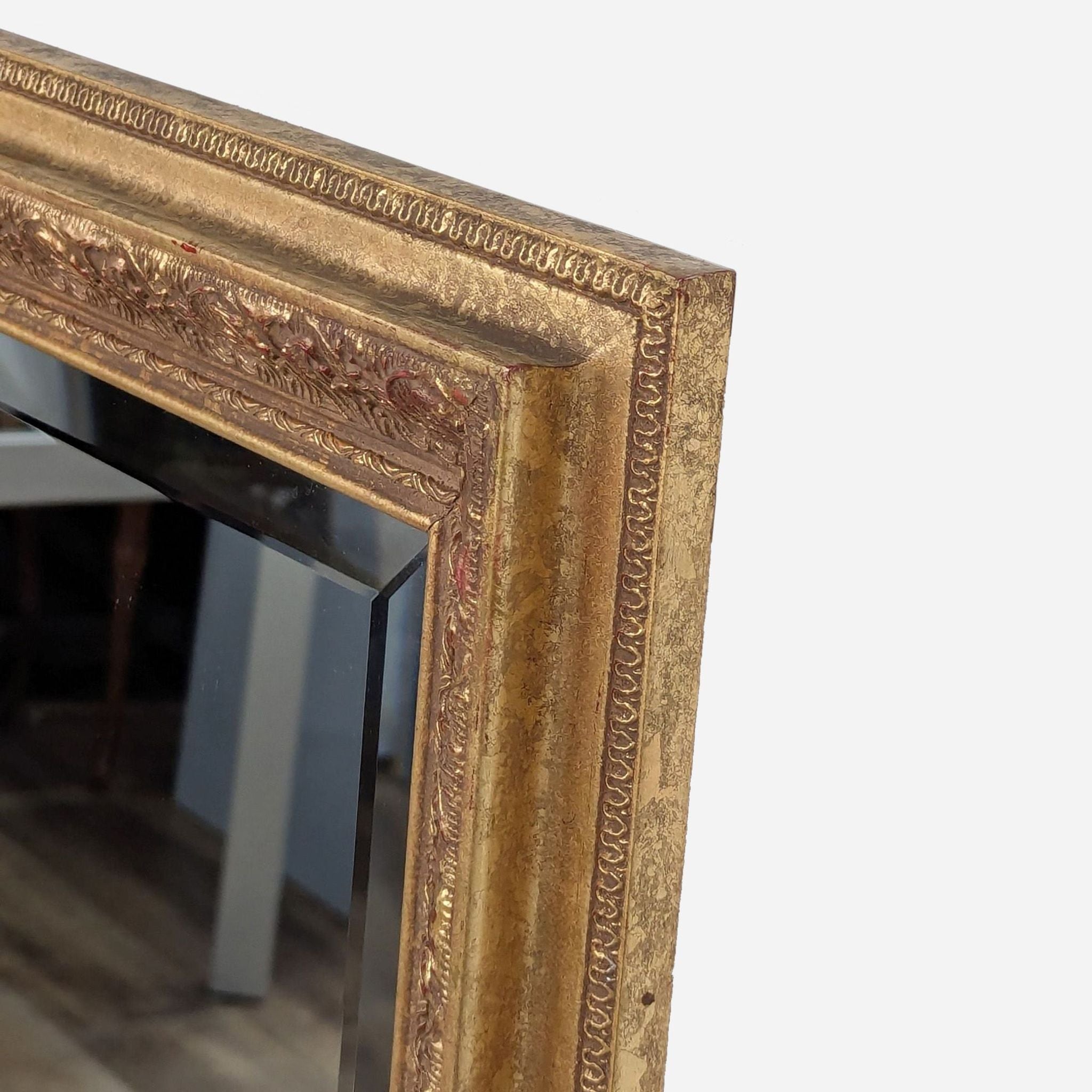 a large antique gold framed mirror