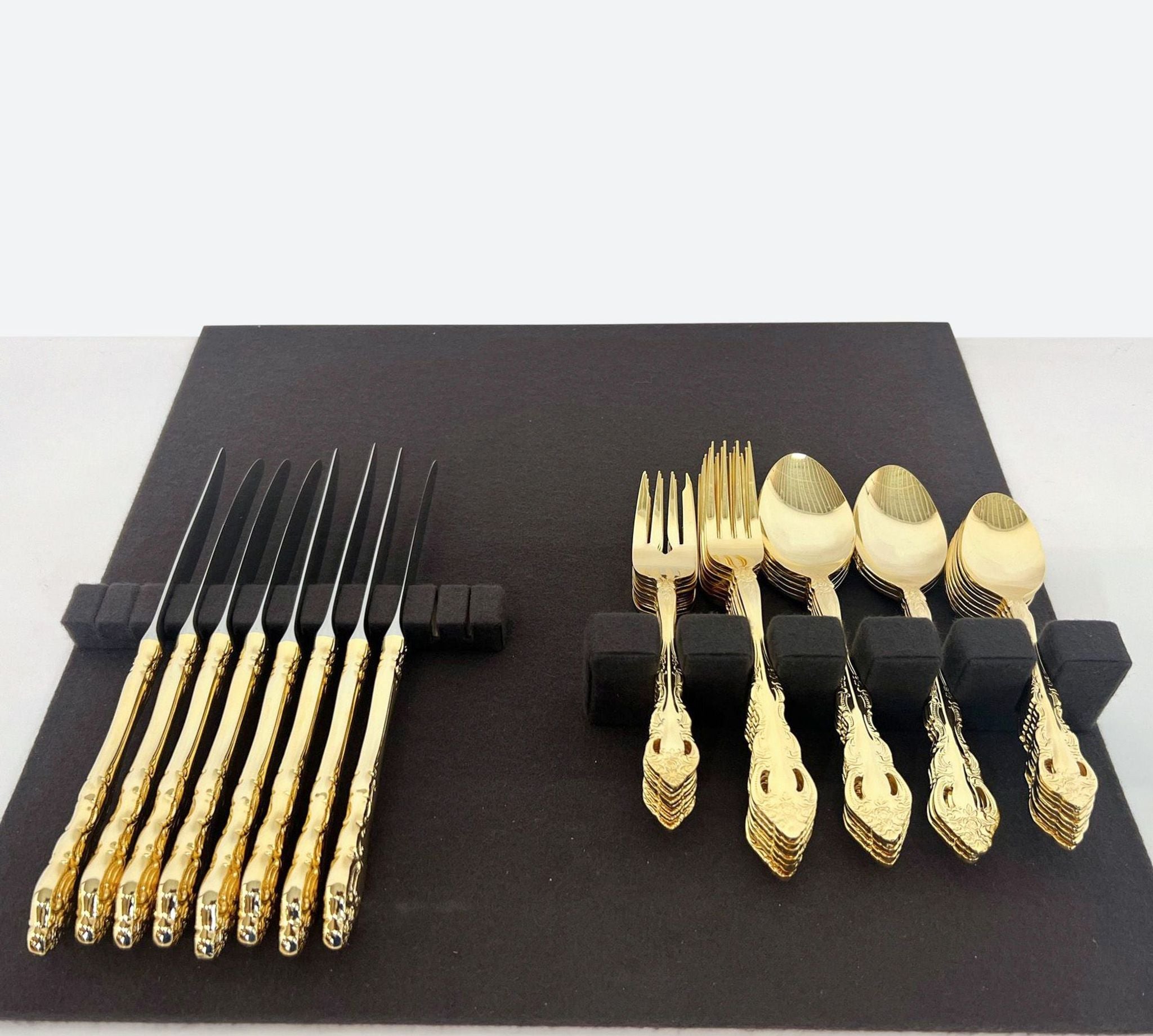 a set of gold cutlery and forks