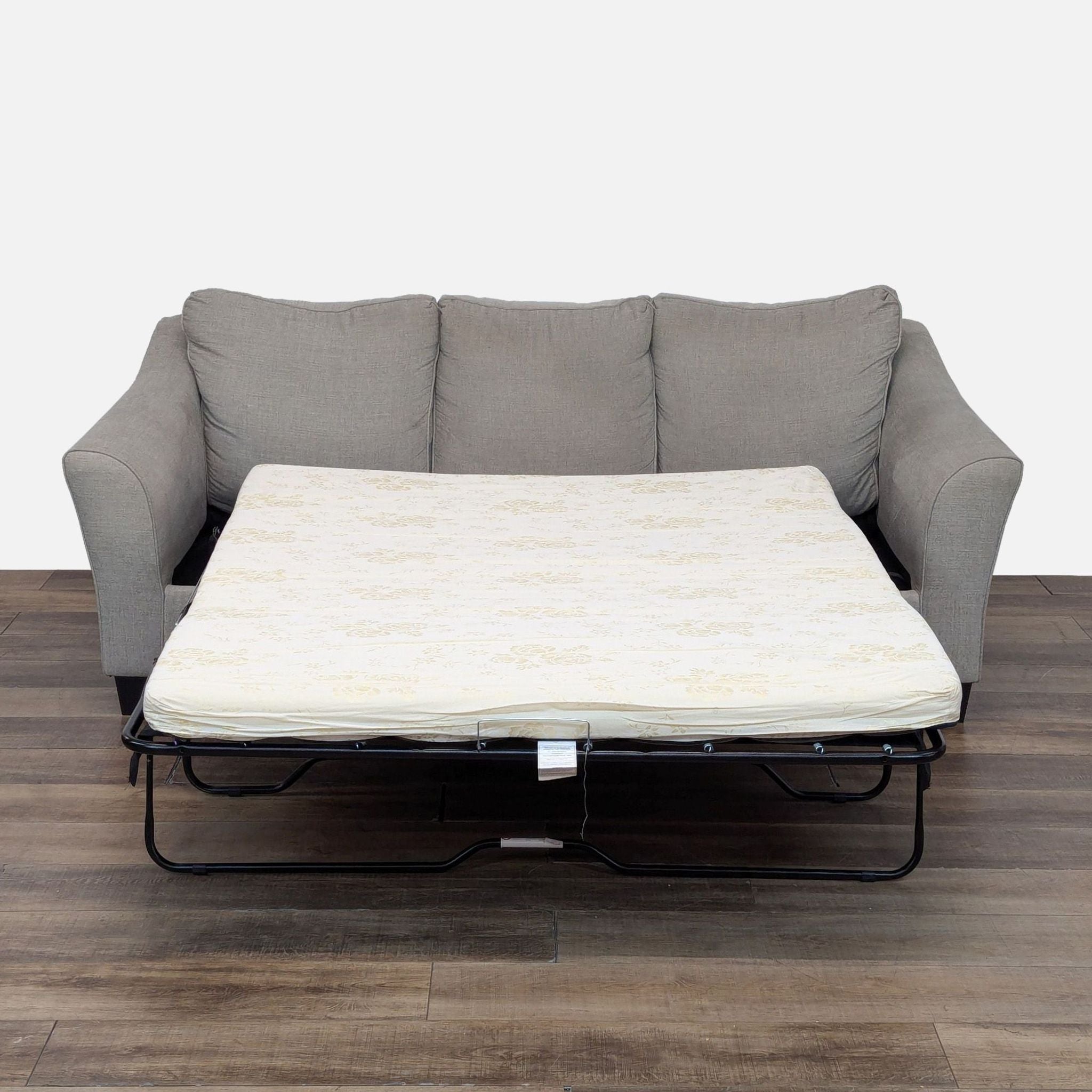 a white couch with a black and white couch cushion 
