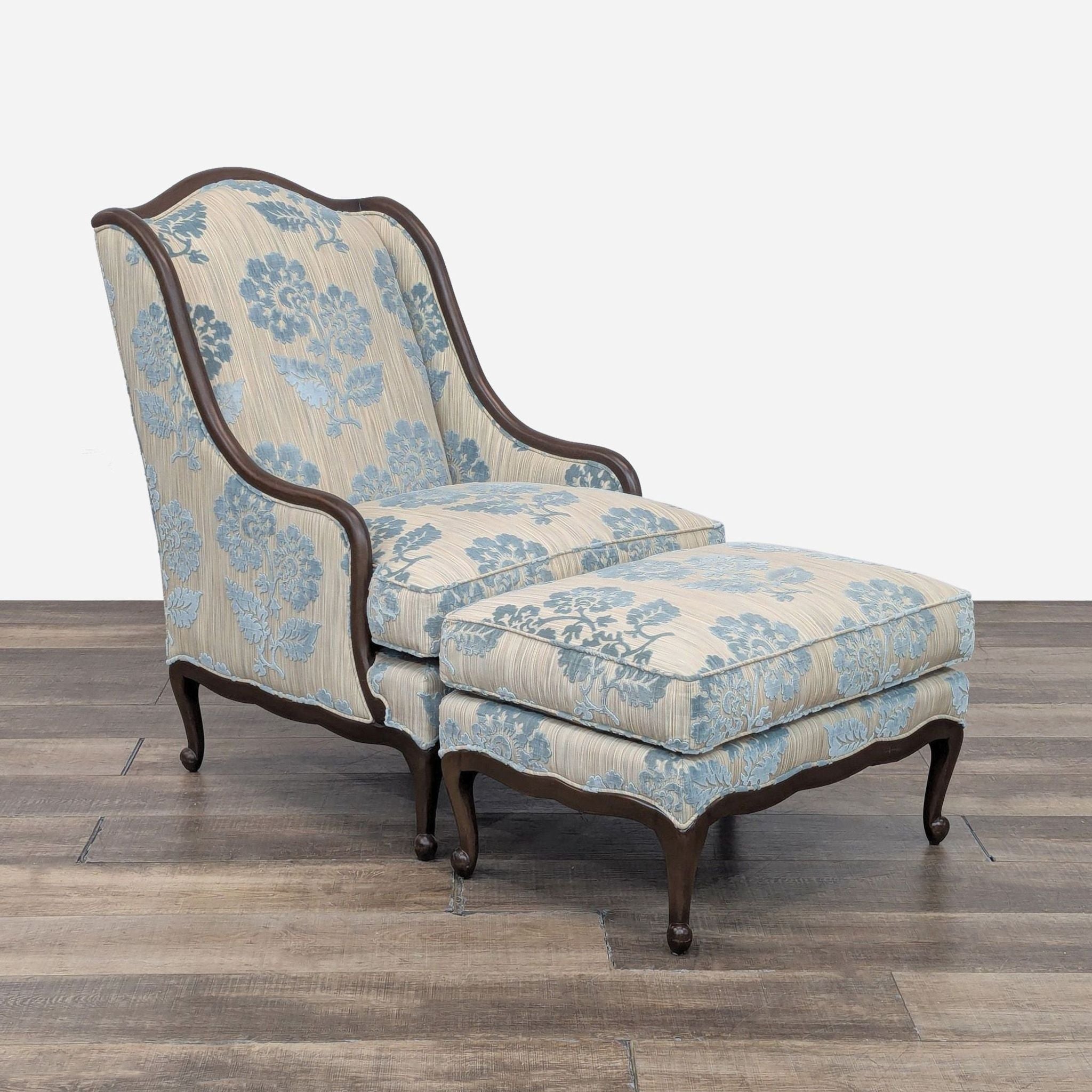 Pearson lounge chair with ottoman featuring blue floral pattern and wooden legs.
