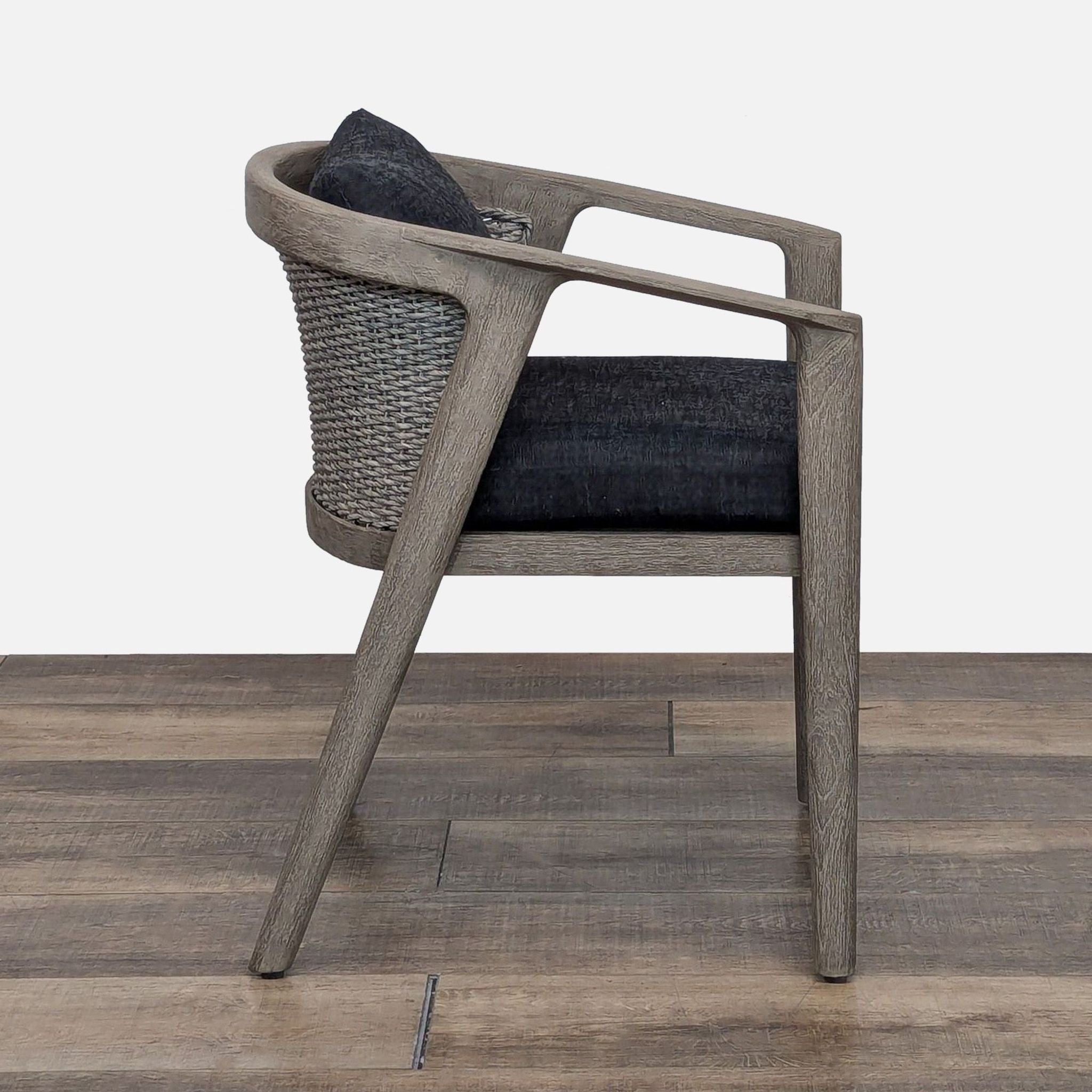 a chair with a wooden handle on a wooden floor 