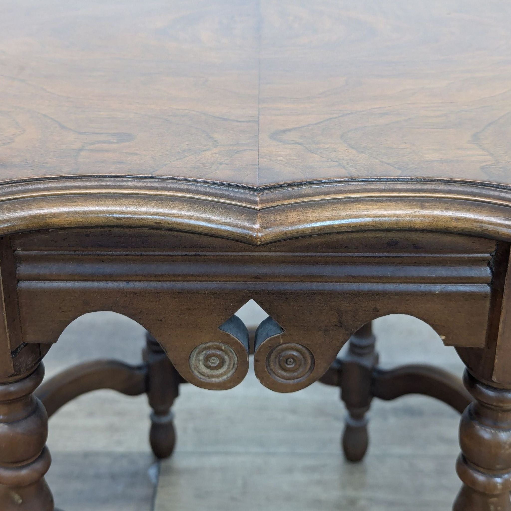Close-up of inlaid top showing intricate woodwork details and carvings.