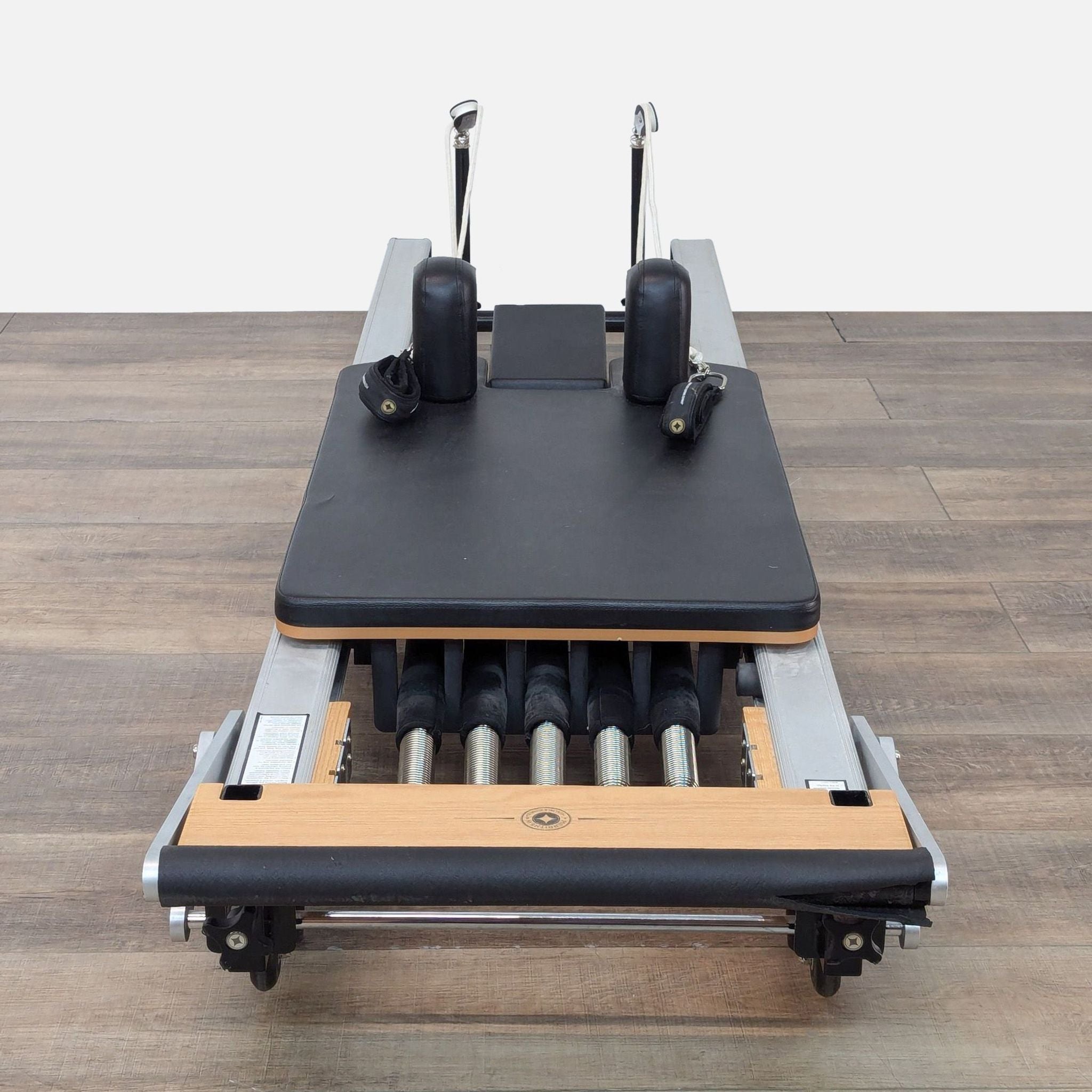 Front view of the Merrithew SPX Reformer showing the smooth carriage and adjustable attachments.