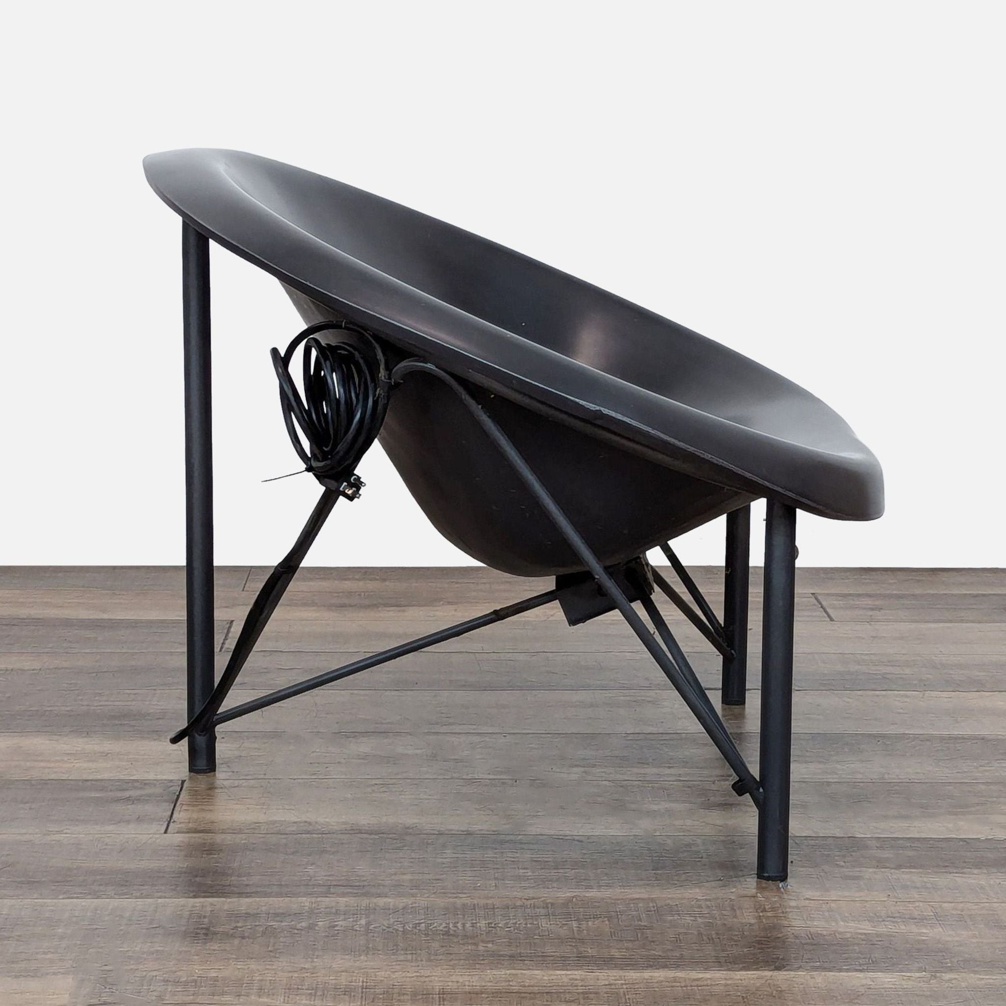 Side view of the Helios chair showing the ergonomic design and integrated wiring.