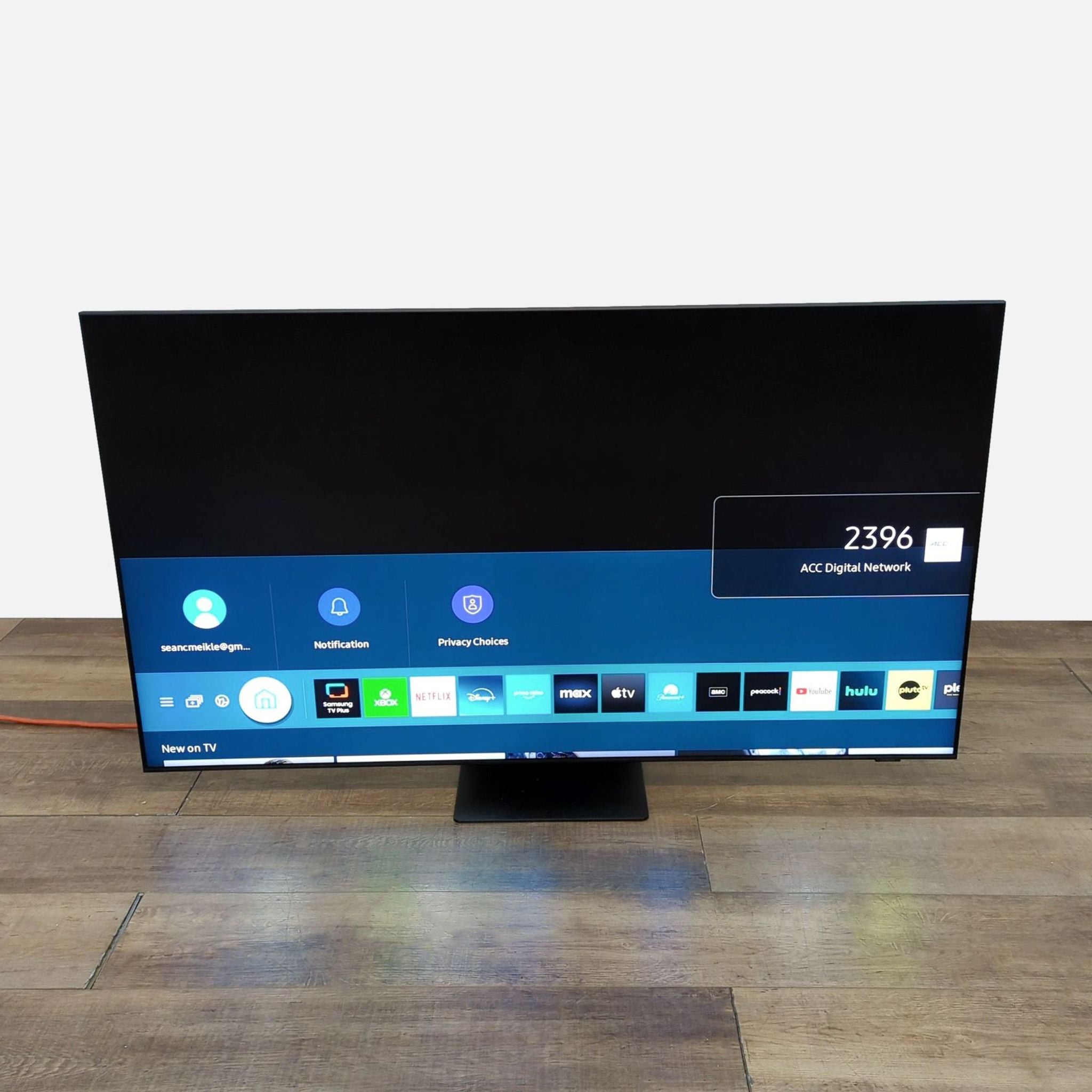 Front view of Samsung 65-inch Neo QLED TV showing interface and app selection.
