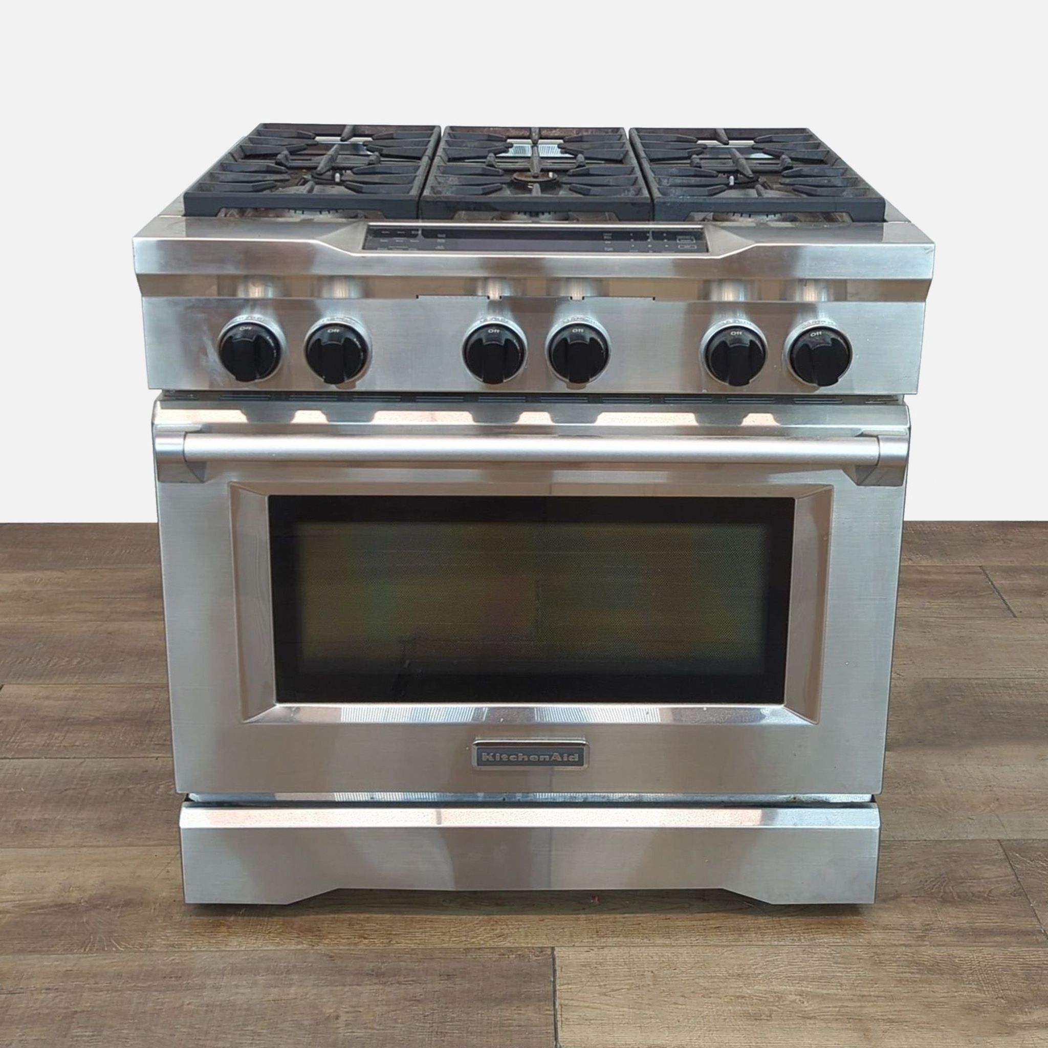 KitchenAid gas range with four burners and a large oven, stainless steel design.