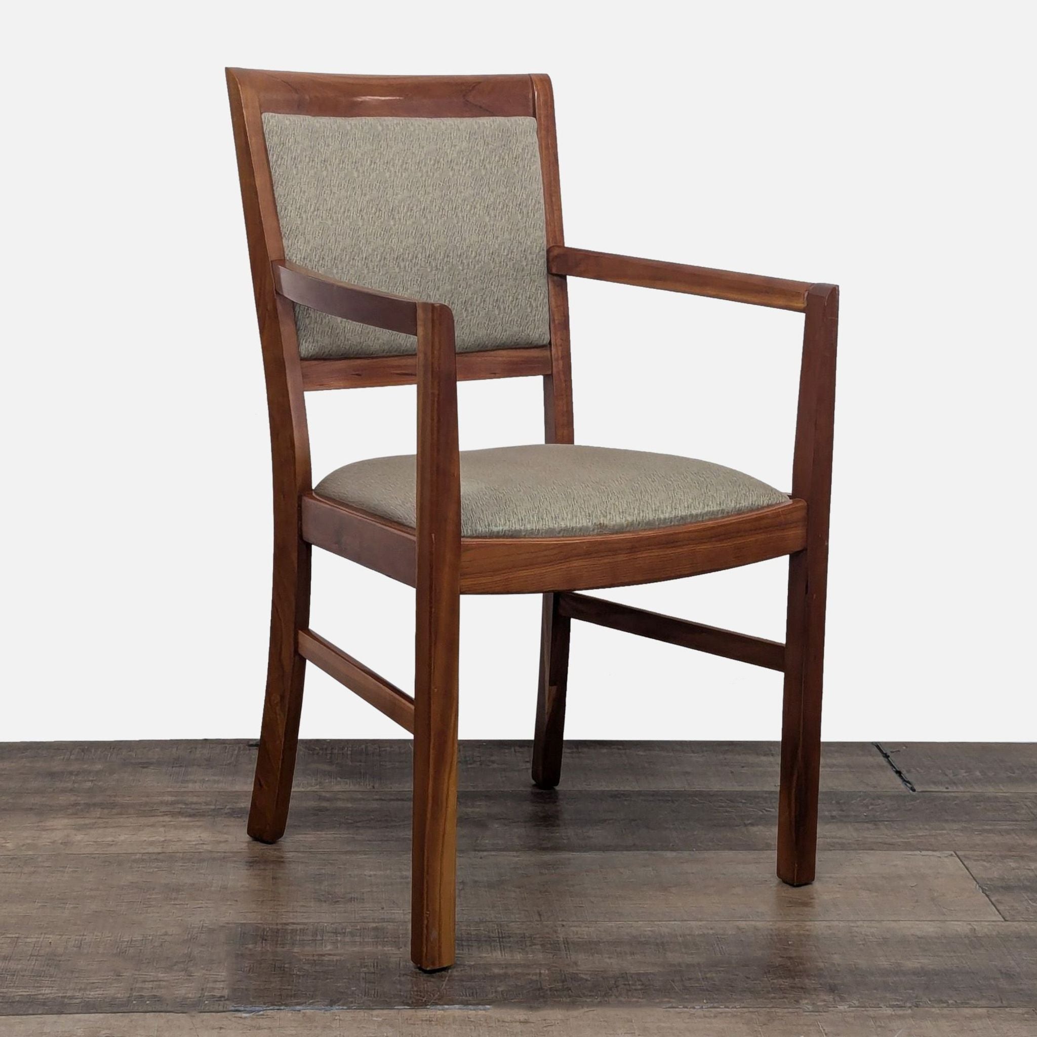 Close-up of a cherry wood arm chair from the Harden dining collection.