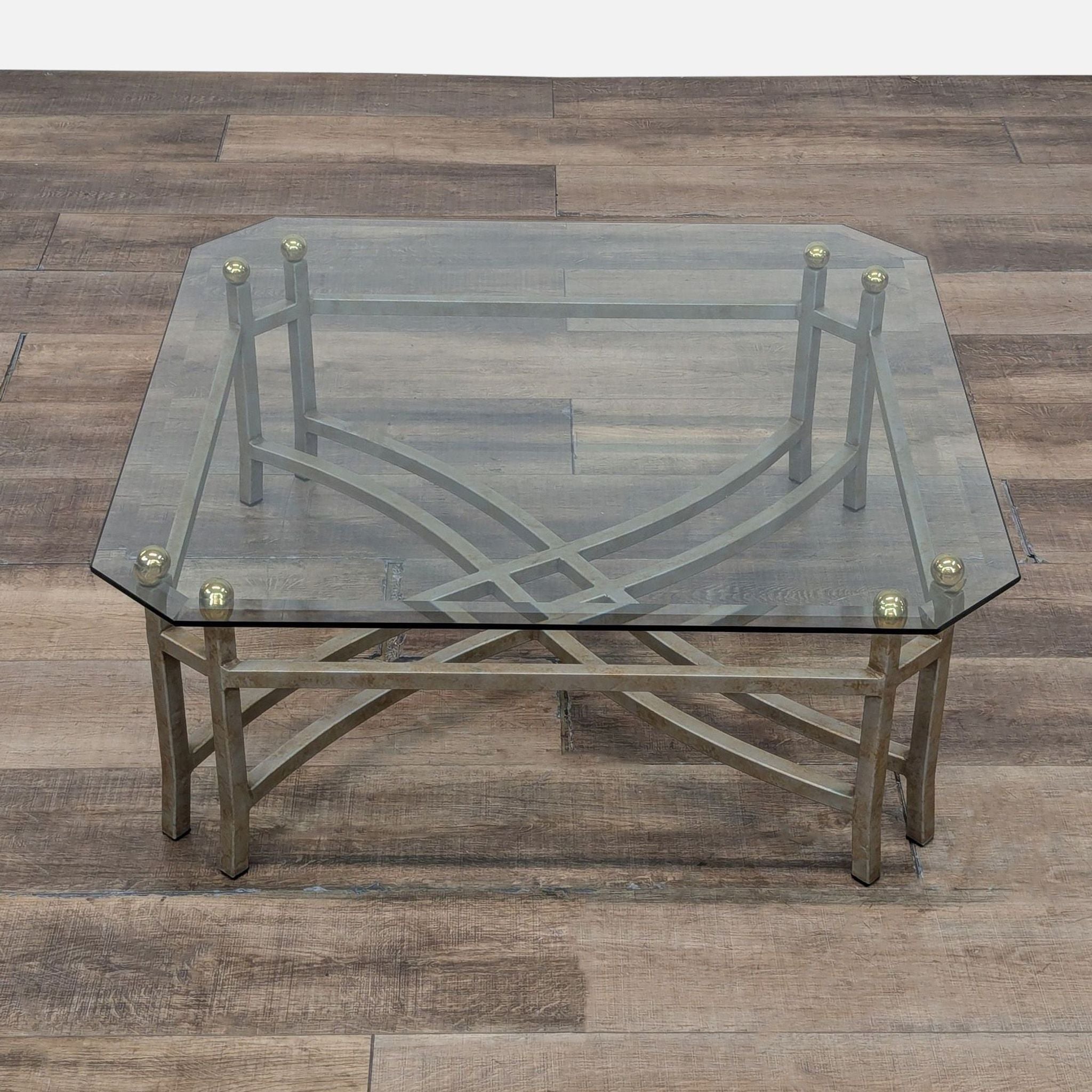 Reperch coffee table with brass and beveled glass design.