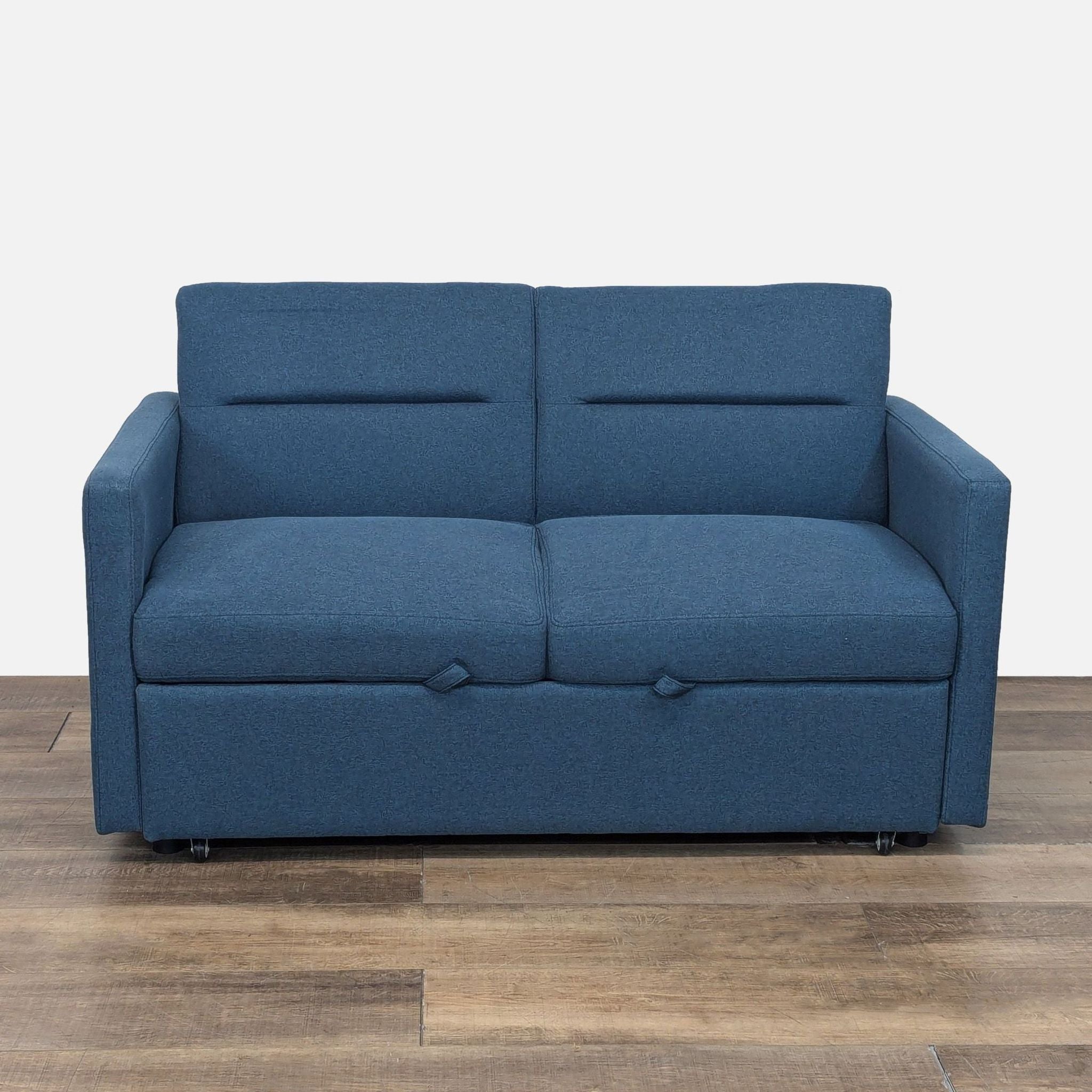 Blue sofa bed with microfiber upholstery, by Latitude Run, shown in a living room setting.
