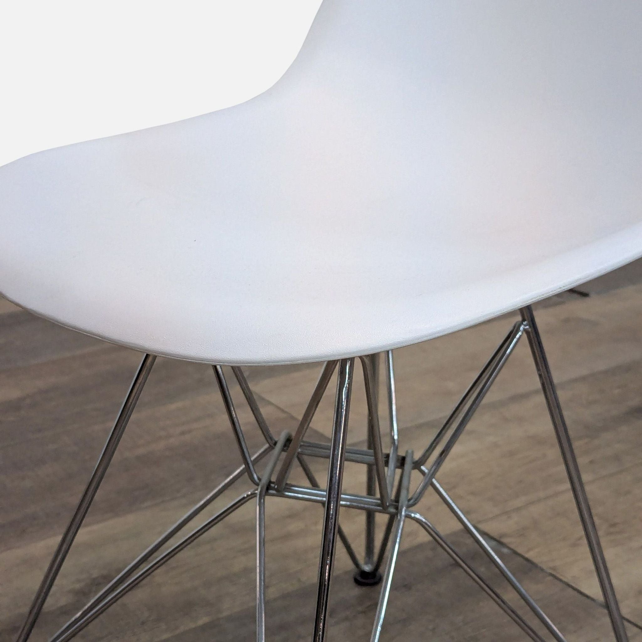 Close-up of Reperch dining chair seat and metal frame.
